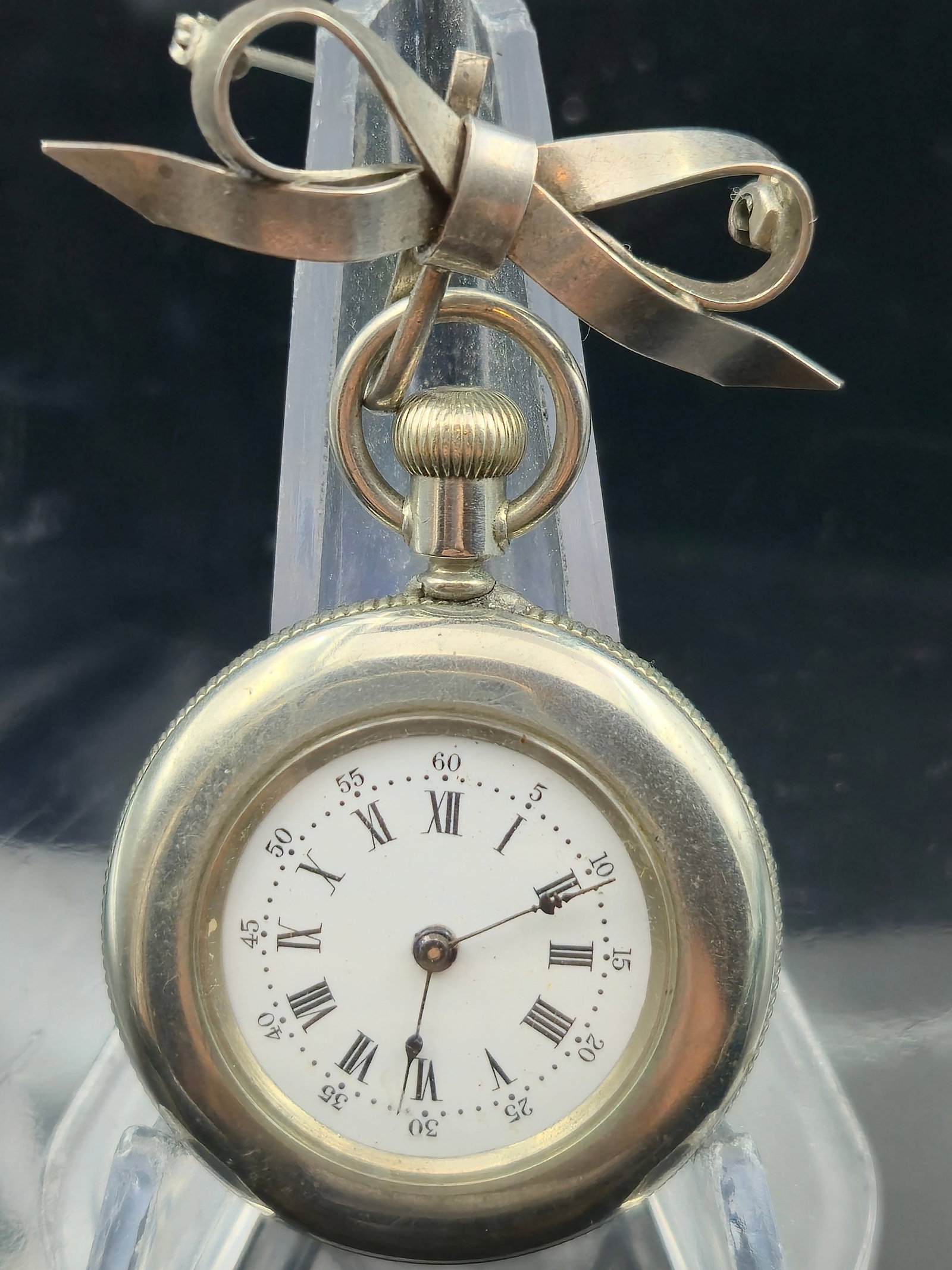 Vintage Addison Ladies Pocket Watch w/ Sterling Bow Brooch: Vintage Addison Trade Mark ladies pocket watch, U.S.A. marked gilt movement with decorative damaskeening on balance cock. White enamel dial with Roman numerals and outer minute track, blued hands. Sil