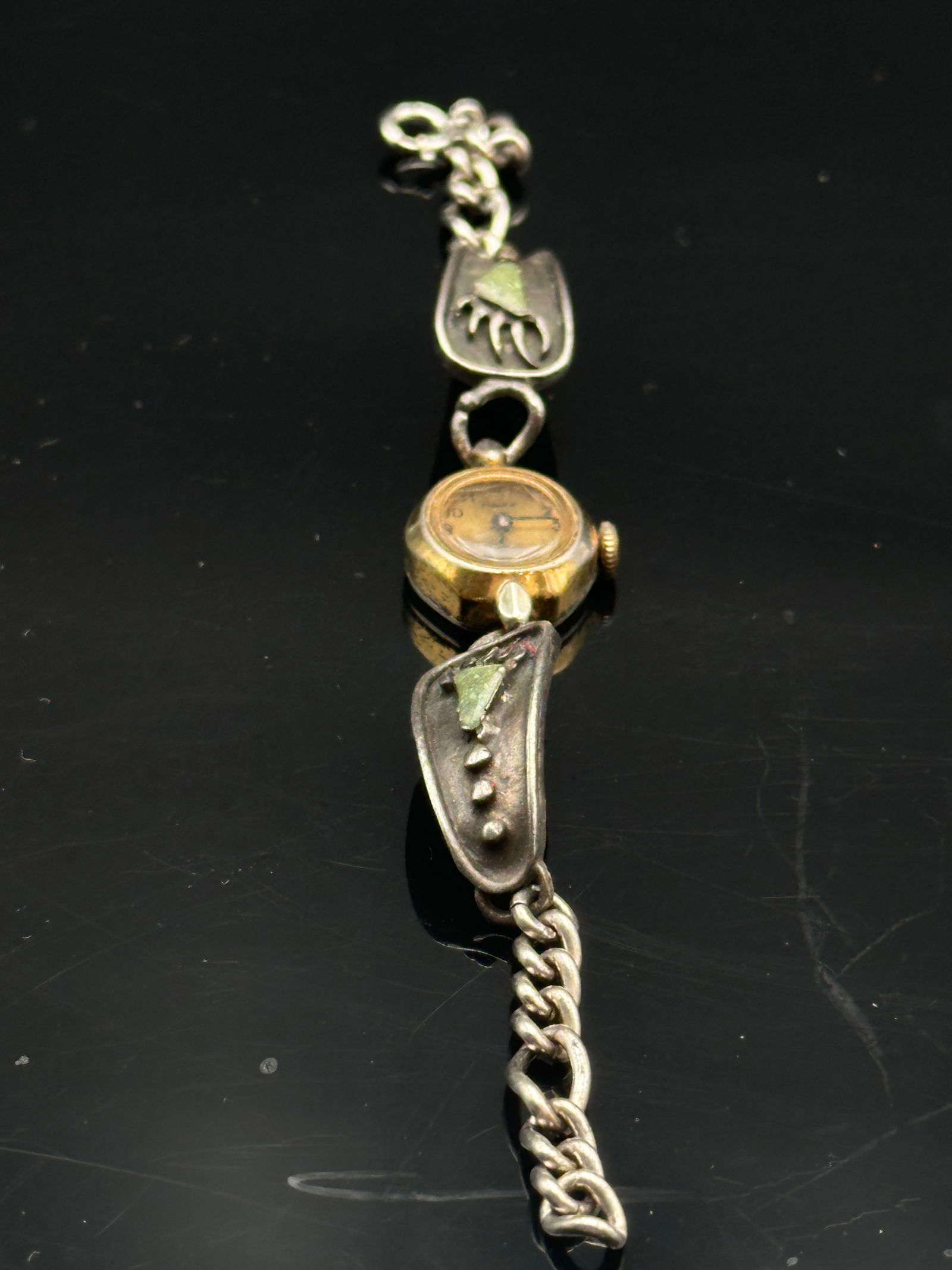 Vintage Timex Women’s Wristwatch with Southwestern Style Sterling Silver Bracelet: Unique vintage Timex women’s wristwatch with a gold-tone bezel and stainless steel back, paired with a Southwestern style sterling silver bracelet. The bracelet features hand-tooled designs with sma