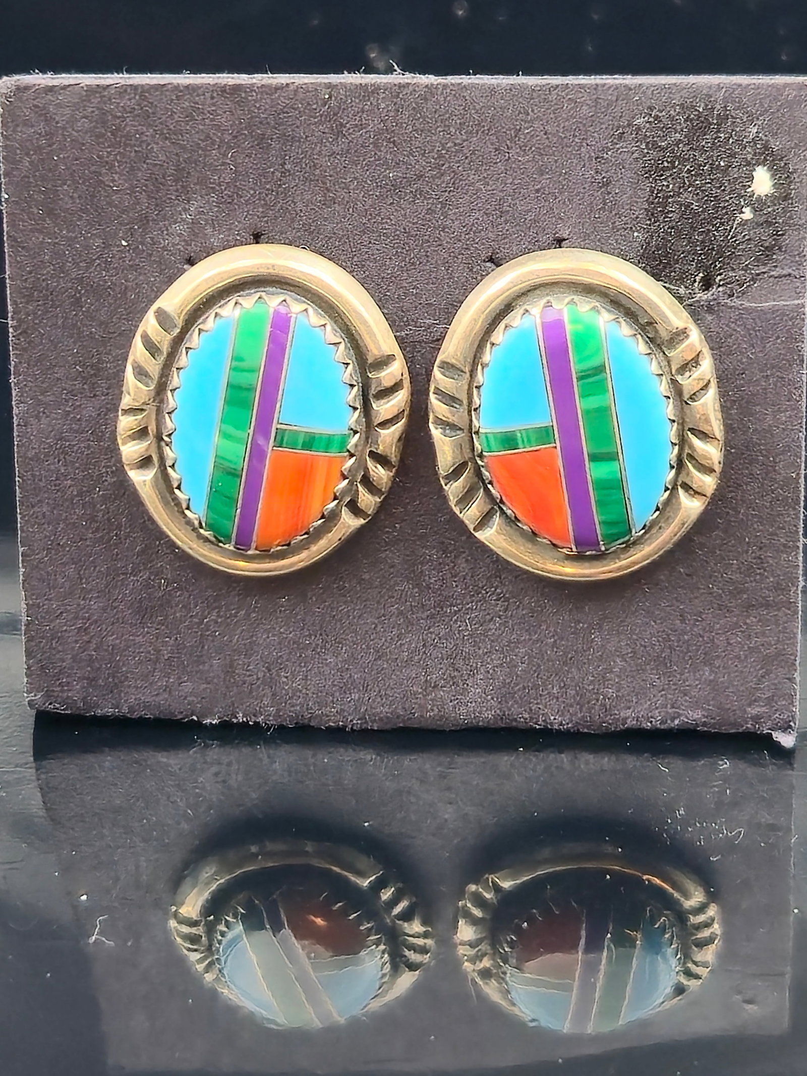 Richard Begay Navajo Sterling Silver Multi-Stone Inlay Earrings, 4.9g: Pair of vintage earrings by Richard Begay (Navajo, 1953–2013), crafted in sterling silver and set with colorful stone inlay in a geometric oval pattern. The design incorporates turquoise, coral, mal