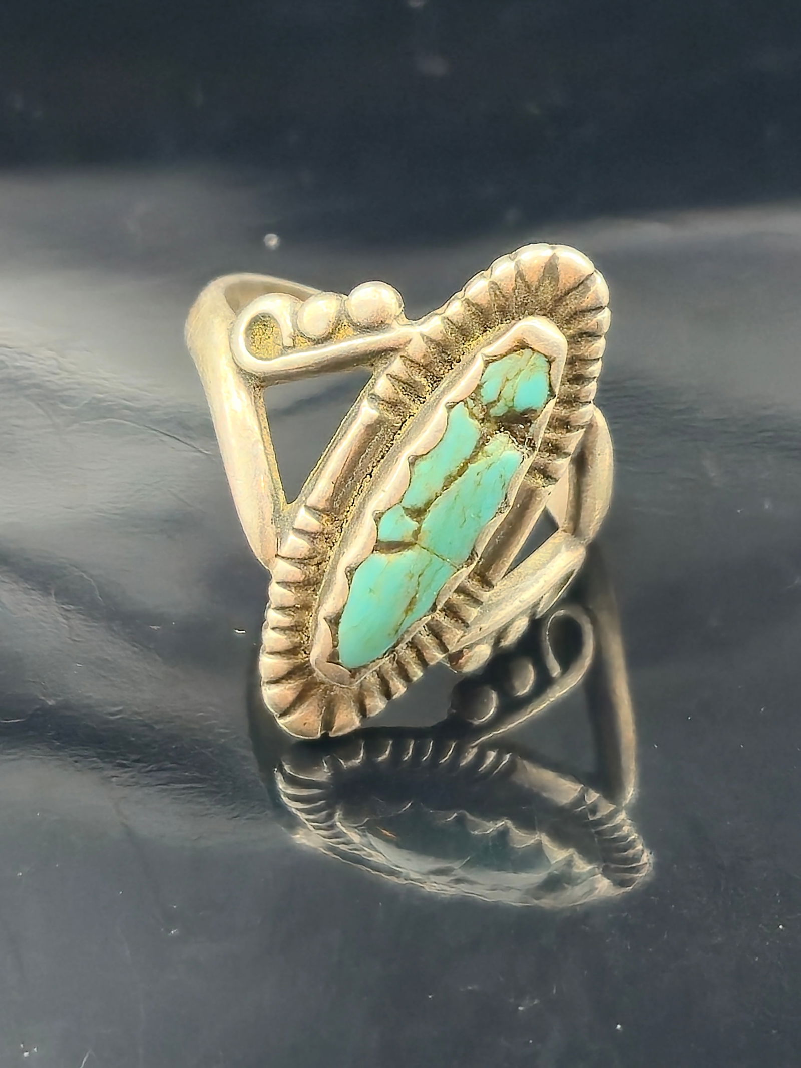 A vintage Navajo sterling silver ring featuring a turquoise cabochon with natural brown/black matrix (1 of 6)