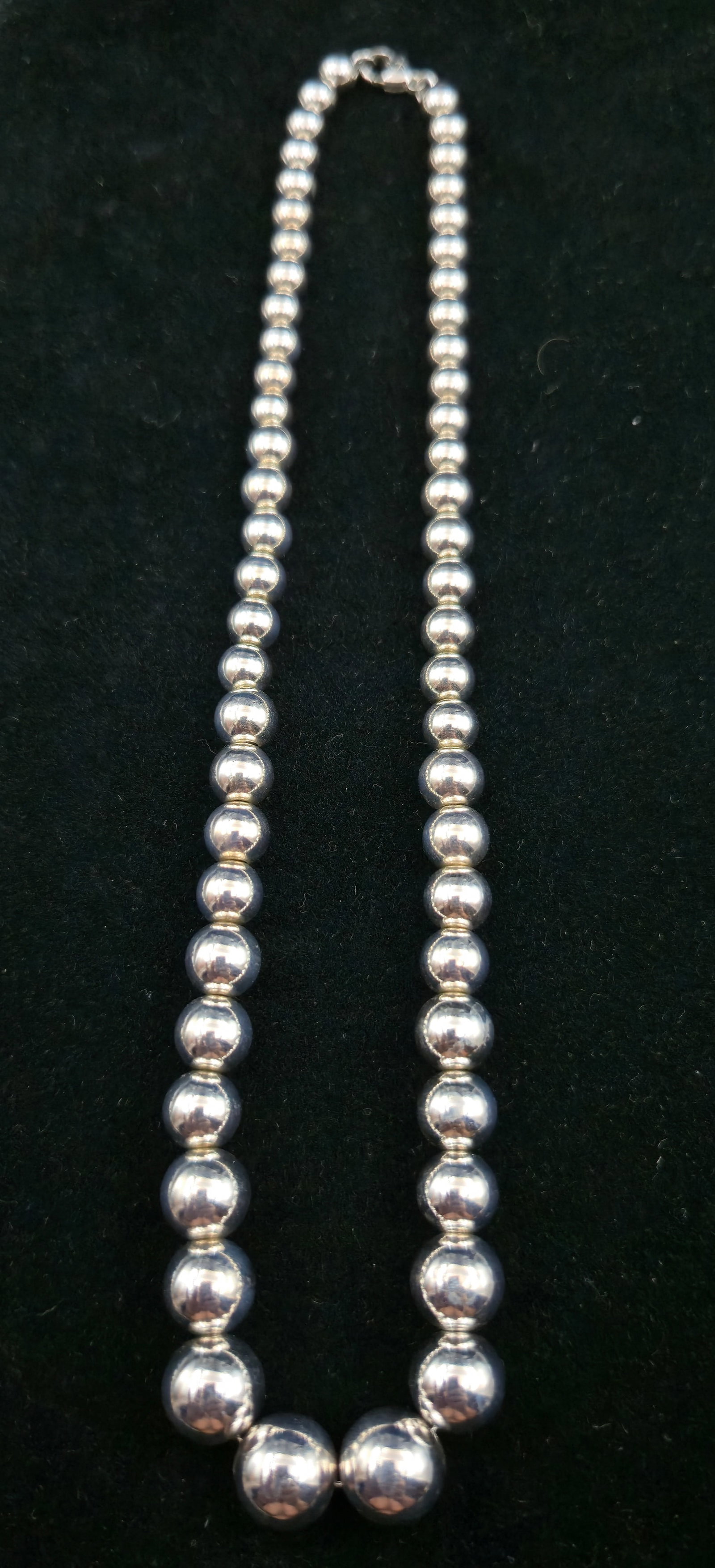 Sterling Silver Graduated Bead Necklace with Anchor Hallmark (.925): Elegant vintage sterling silver bead necklace featuring graduated round beads with a lobster clasp closure. The clasp is stamped .925 for sterling silver and bears an anchor hallmark, indicating quali