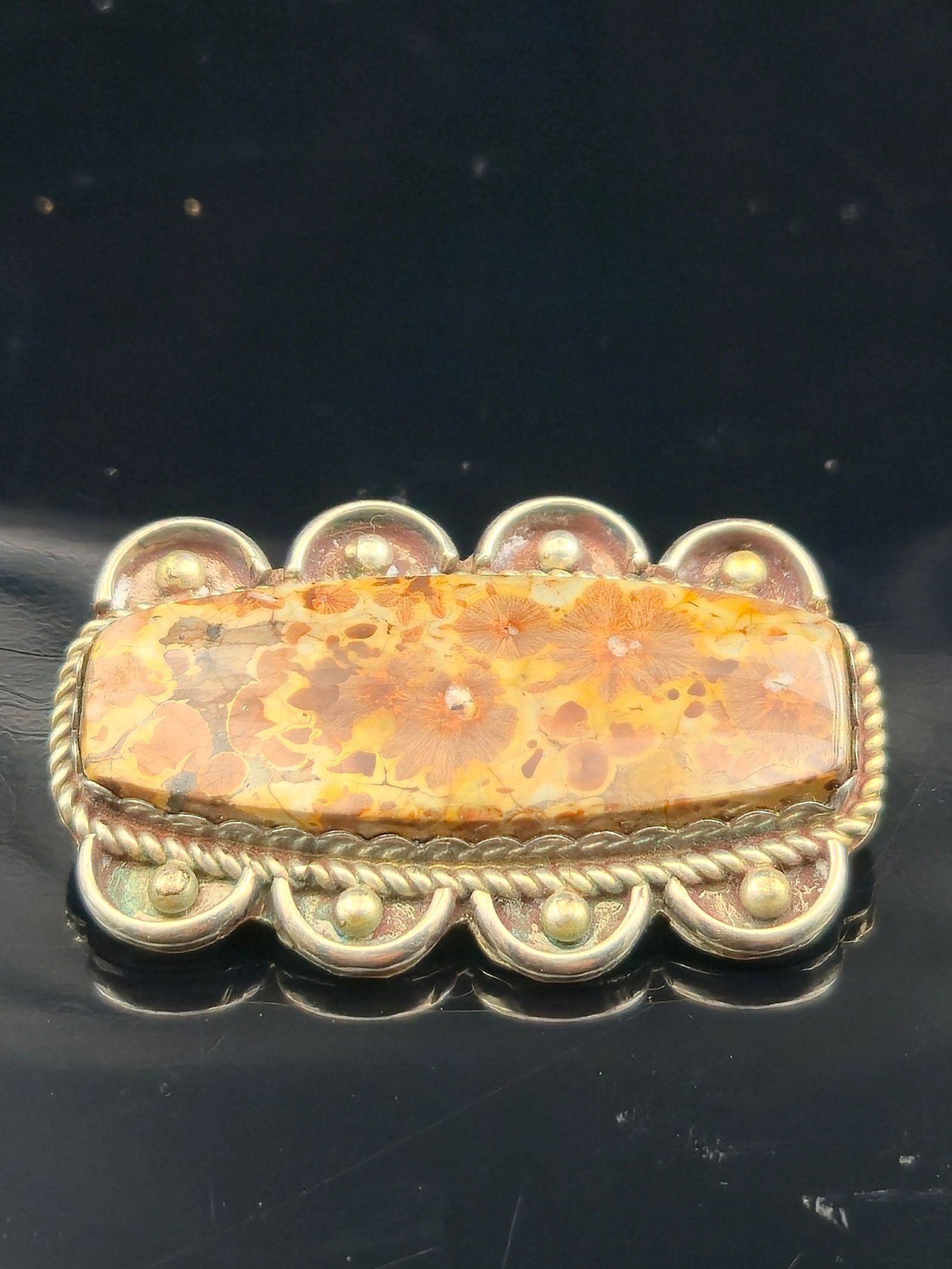 Agnes Seebass Sterling Silver Brooch w/ Fossil Coral, 12.6g: Vintage sterling silver brooch by acclaimed silversmith Agnes Seebass, signed Sterling. The design features a polished fossil coral cabochon with striking flower-like inclusions, framed by scalloped s