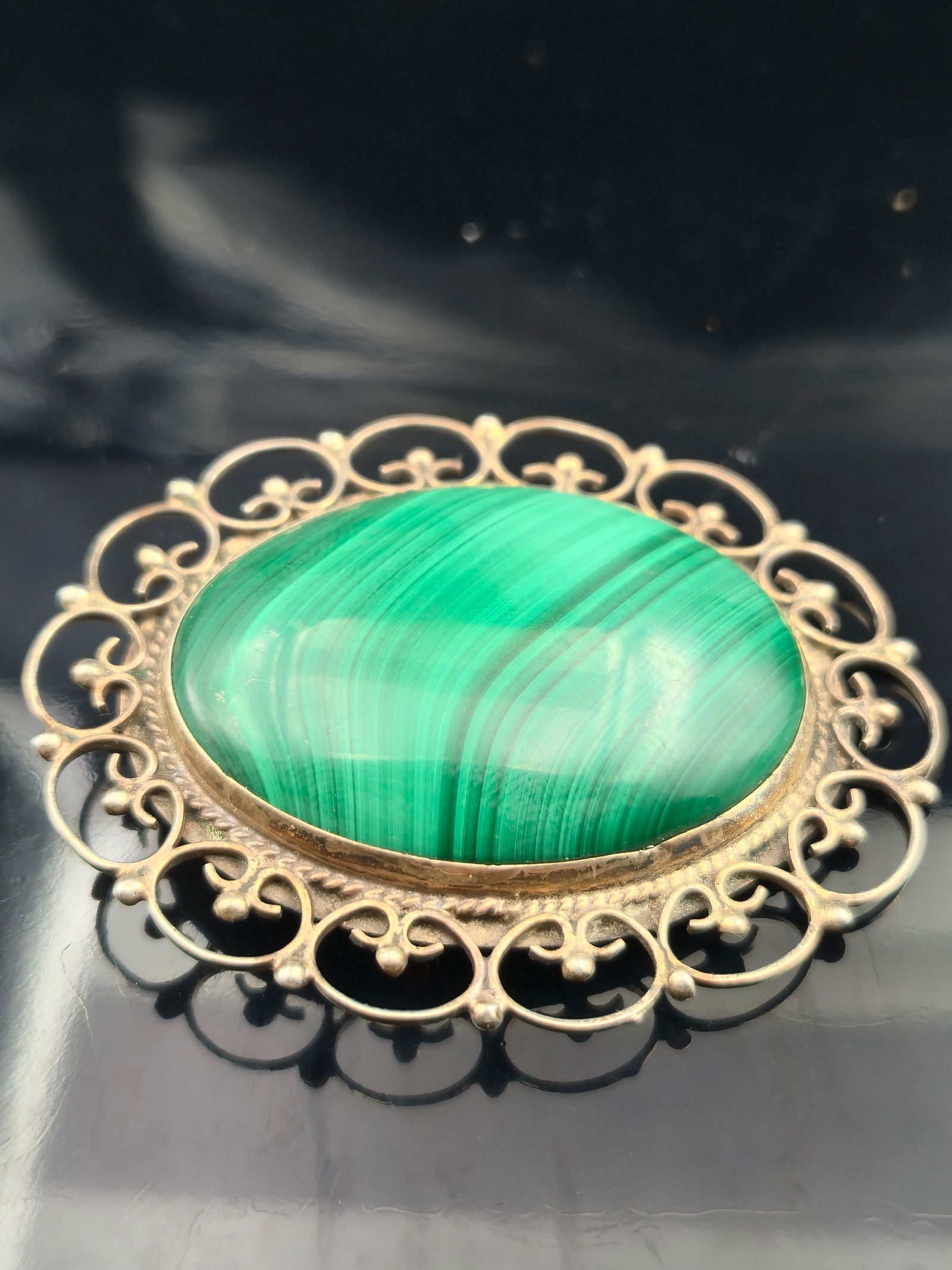 Vintage Mexican Sterling 925 Malachite Brooch Pendant, Marked 85 JS: Elegant vintage Mexican sterling silver brooch featuring a striking oval malachite cabochon with vivid natural banding in shades of deep and light green. The stone is framed in a decorative filigree b
