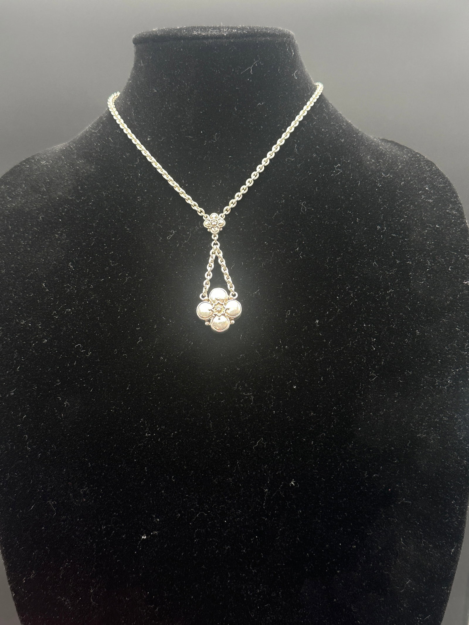 Sterling Silver 925 Floral Drop Necklace: An elegant sterling silver 925 necklace featuring a floral-inspired pendant design suspended from a sturdy silver chain. The pendant is crafted in a four-petal floral form with a raised beaded center,