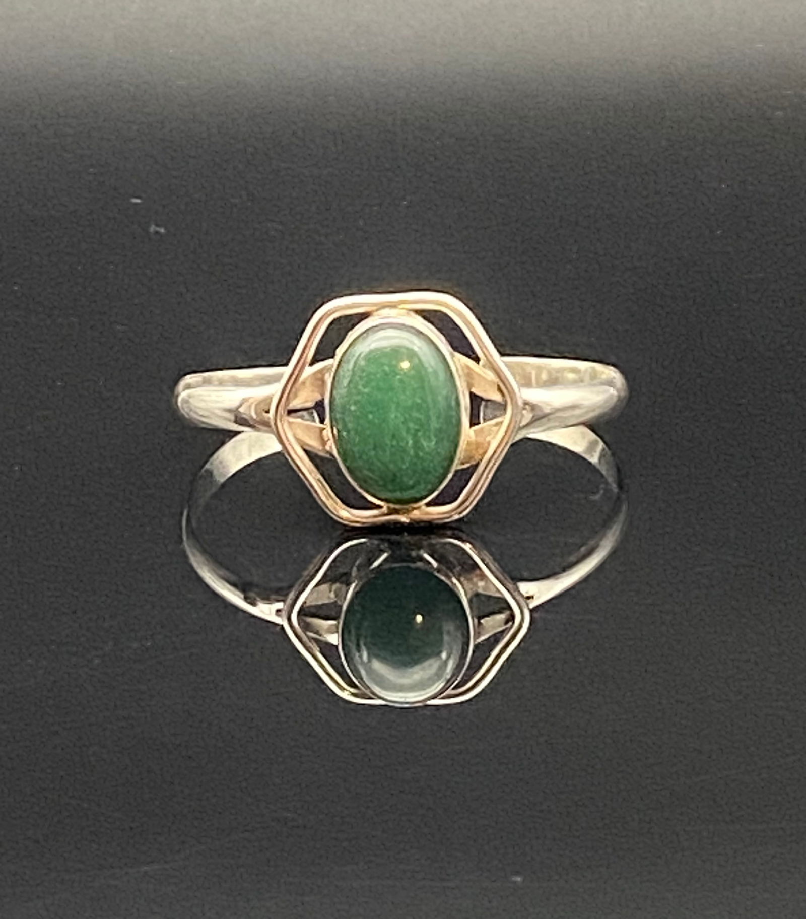 Mexican Sterling Silver Green Aventurine Cabochon Bracelet (Taxco): A striking handcrafted sterling silver bracelet from Taxco, Mexico, set with an oval green aventurine cabochon at the center. The stone is framed in a bold geometric openwork bezel, blending modernist