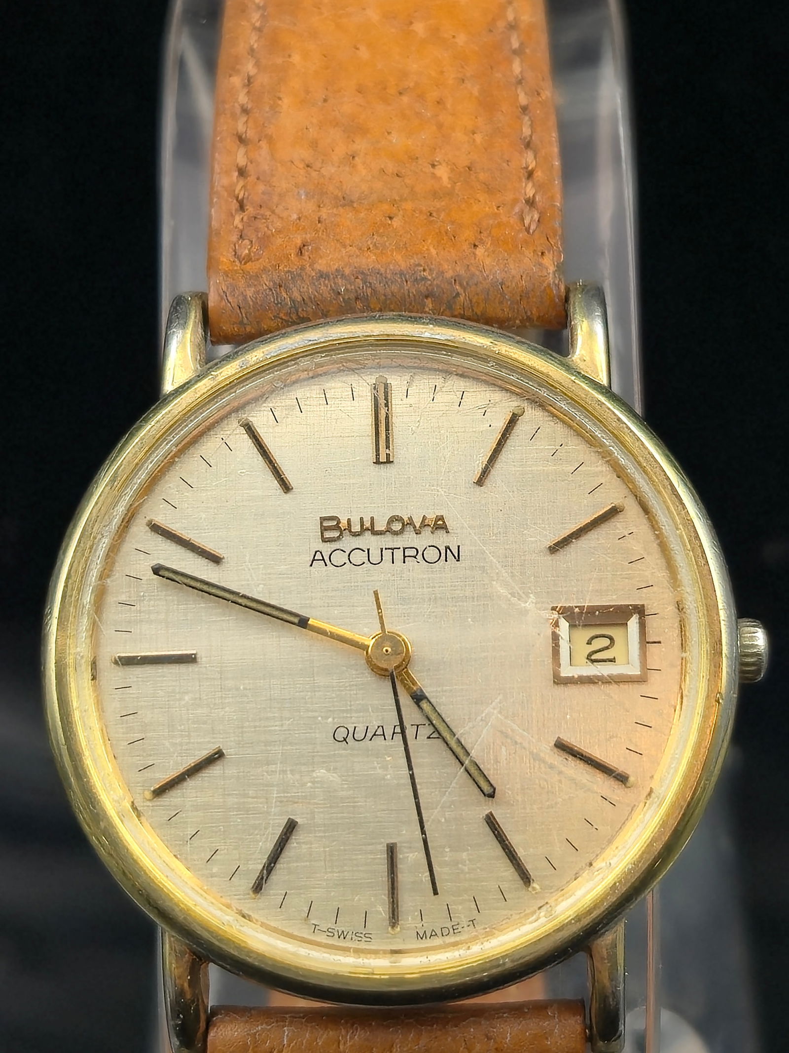 Bulova Accutron Quartz Dress Watch 10K RGP Back Date Running: Vintage Bulova Accutron men’s wristwatch, c. late 1970s–1980s. Features a gold-tone case with 10K Rolled Gold Plate back, base metal bezel, and stainless inner back. Brushed silver/champagne dial