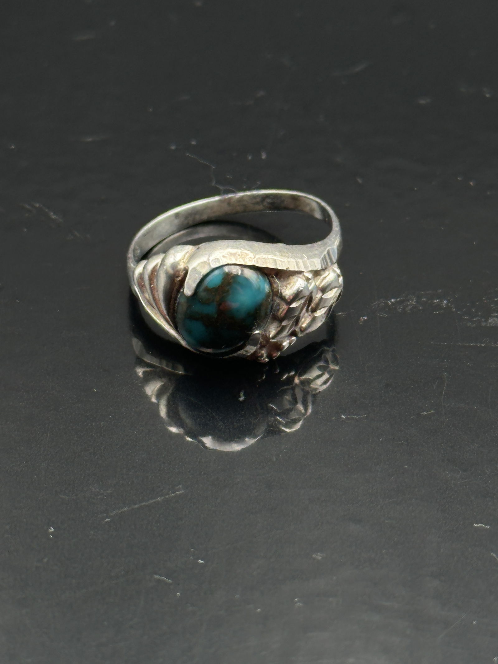 925 Sterling Silver Copper Matrix Turquoise Ring: A bold sterling silver ring featuring a domed oval turquoise cabochon with striking copper matrix veining. The stone is securely bezel-set in a sculpted silver mount with smooth shoulders, giving the