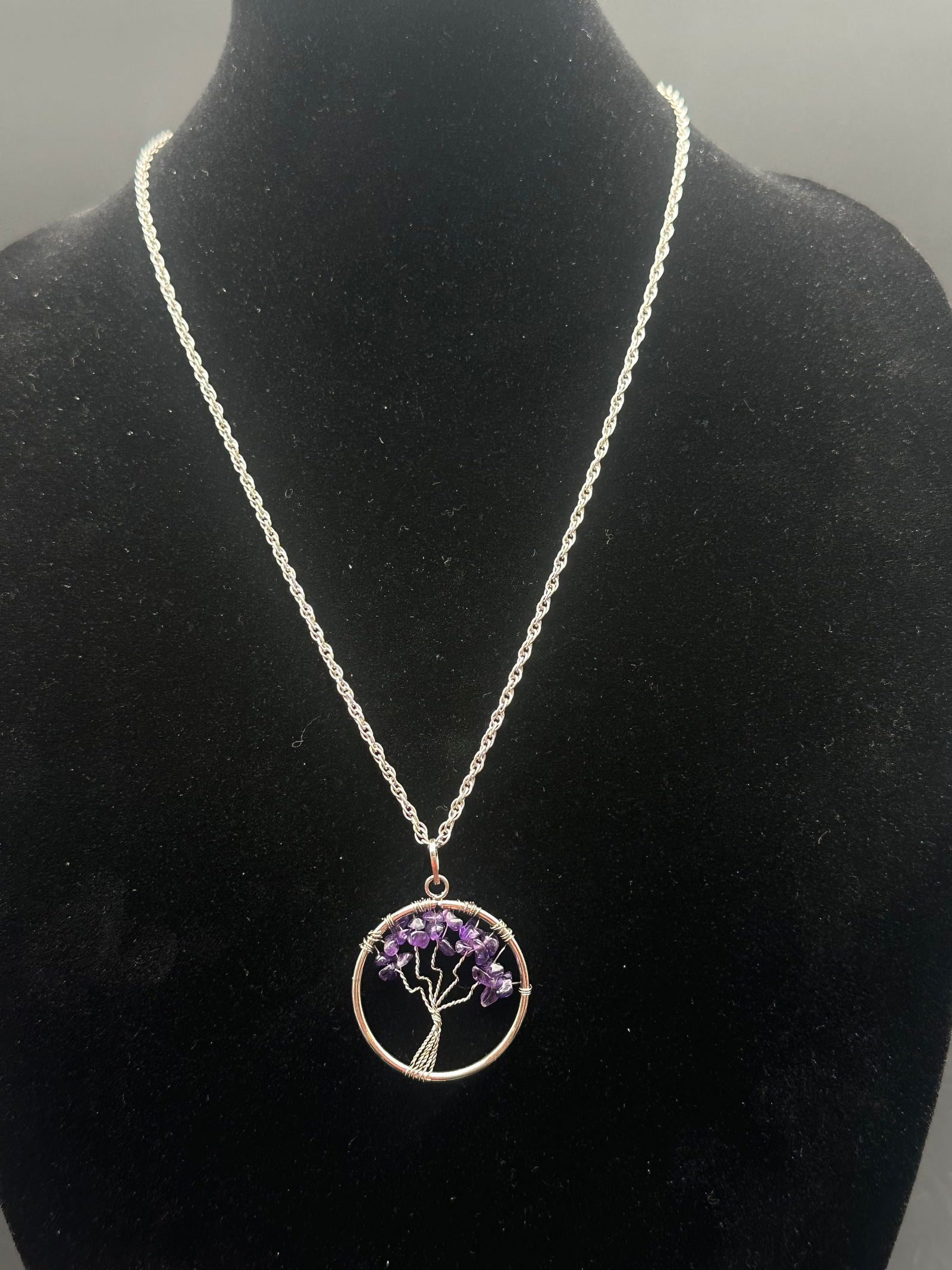 Sterling Silver Tree of Life Necklace w/ Amethyst Gemstone Chips: Sterling silver chain with circular Tree of Life pendant crafted from twisted silver wire and set with natural amethyst gemstone chips. Symbolic design representing growth and harmony, with vibrant pu