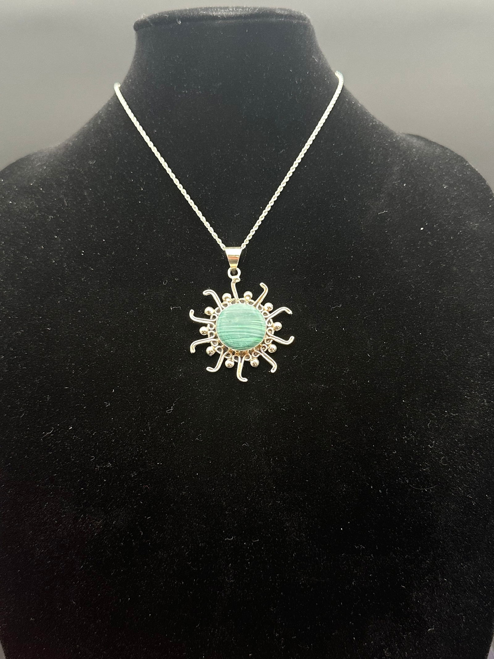 Sterling Silver Italian Chain with Malachite Sunburst Pendant: A striking sterling silver necklace featuring a rope-style chain marked 925 Italy with lobster clasp, paired with a bold sunburst pendant. The pendant is crafted in sterling silver and set with a roun