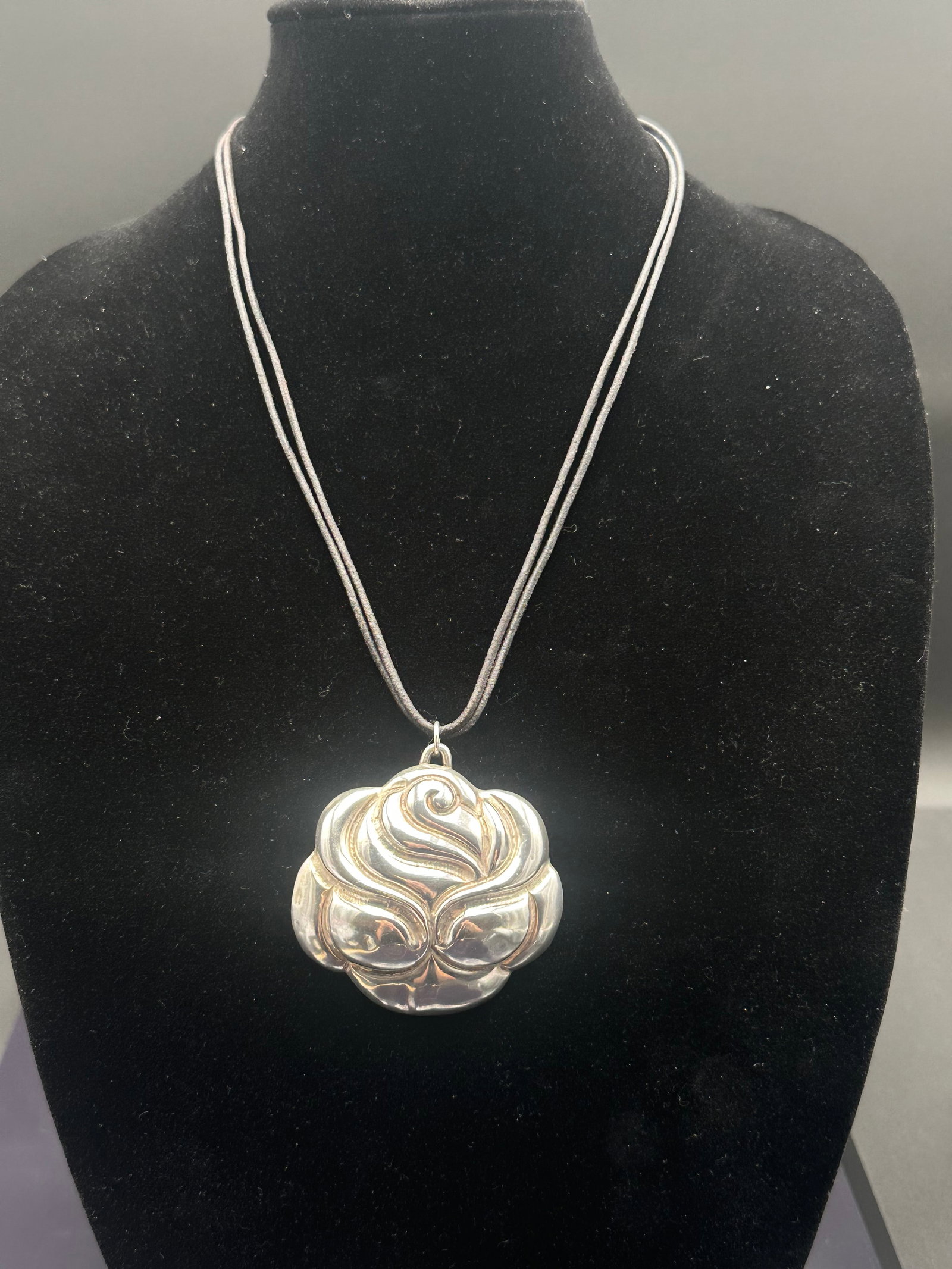 Vintage Mexican Sterling Silver Modernist Floral Pendant Necklace: Large vintage sterling silver pendant in a bold sculptural floral/abstract design, suspended on a double black cord necklace. Marked “Silver Made in Mexico” on the reverse, indicating mid-20th