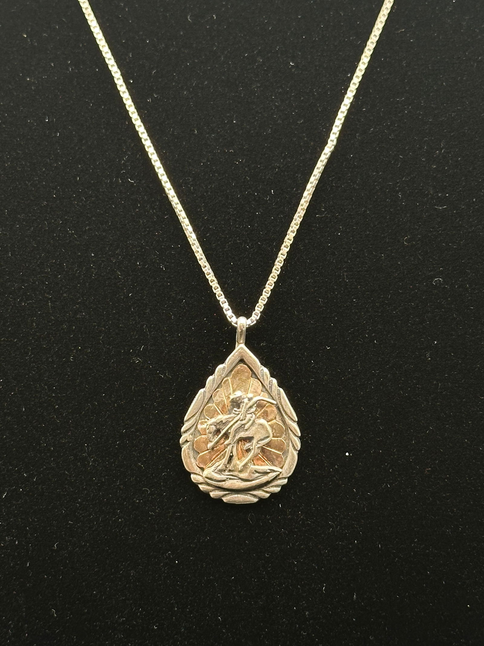 Vintage Sterling Silver “End of the Trail” Pendant Necklace with Gold-Wash Accent: A vintage sterling silver pendant necklace depicting the iconic “End of the Trail” design with a Native American warrior on horseback in high relief. The pendant features a gold-wash sunburst