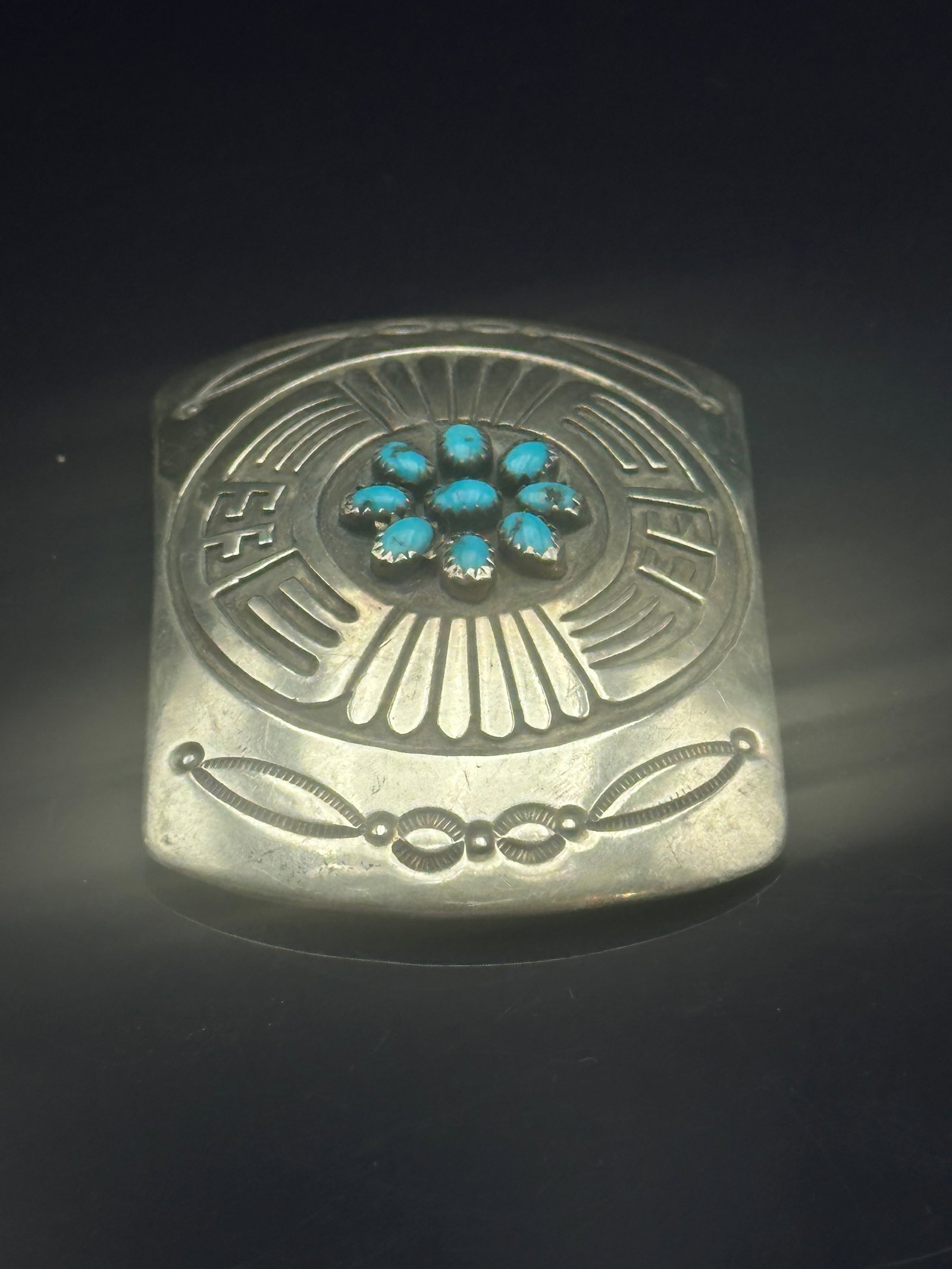 Rosco Scott Navajo Sterling Silver & Turquoise Cluster Belt Buckle: Handcrafted Navajo sterling silver buckle by Rosco Scott, decorated with stamped geometric motifs and set with a central turquoise cabochon cluster in a flower design. Artist’s hallmark “ROSCO SCO