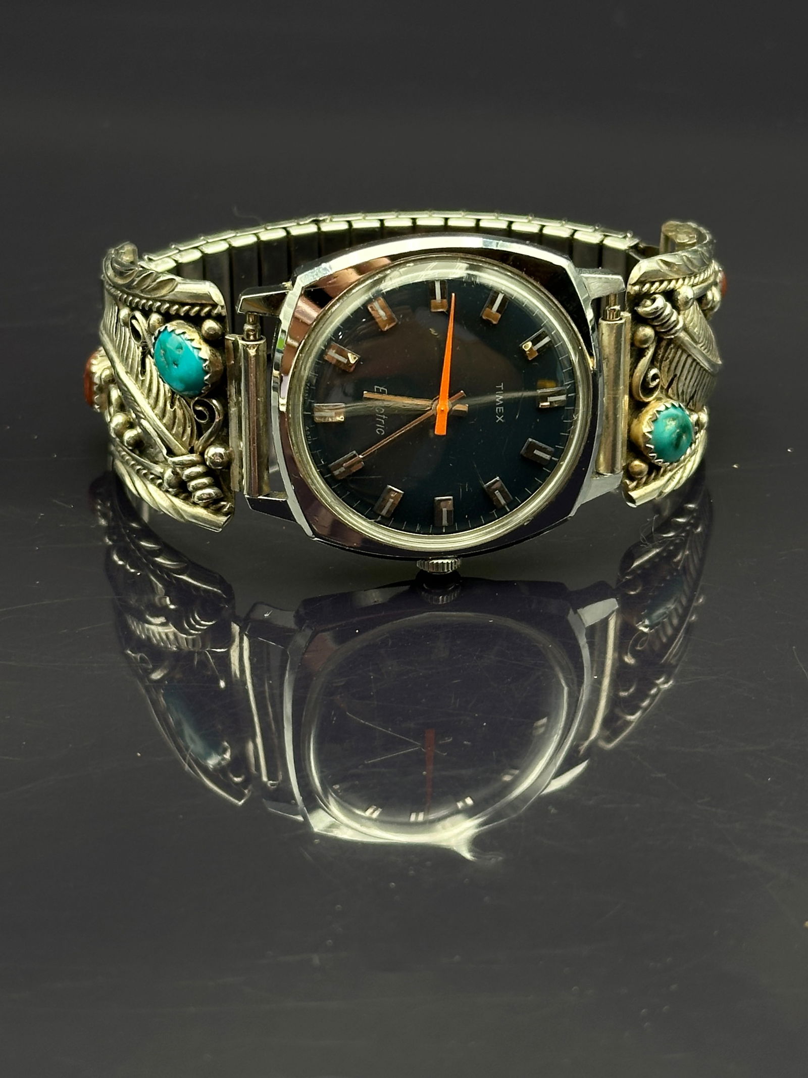 Vintage Timex Electric Wristwatch with Navajo Sterling Silver Turquoise & Coral Tips, 59.7g: Vintage Timex Electric wristwatch accented with handcrafted Navajo sterling silver tips. The tips are decorated with turquoise and coral cabochons, accented by hand-stamped leaf, rope, and bead motifs