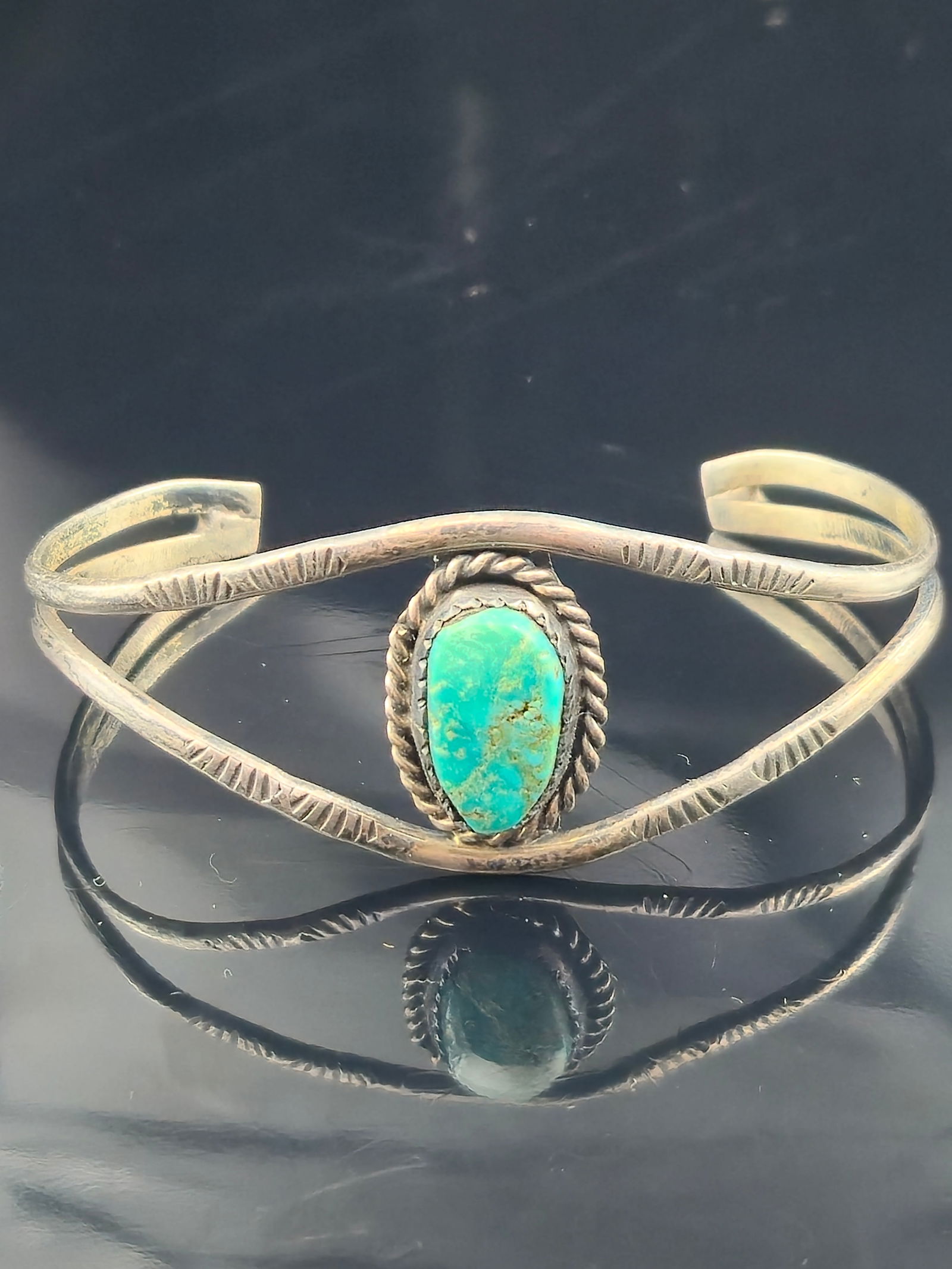 Native American Sterling Silver Turquoise Cuff Bracelet 58mm Wide Hand Stamped Split Band 9.9g: Authentic Native American sterling silver cuff bracelet featuring an oval turquoise cabochon with natural matrix. The stone is set in a hand-tooled bezel with twisted rope surround. The split-band cuf