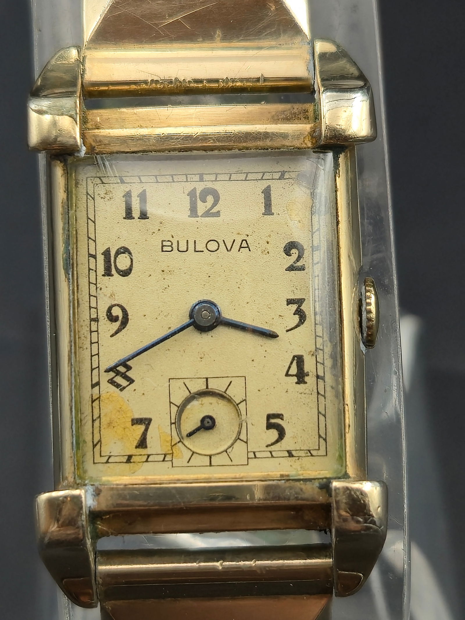 1940s Bulova 21J Rectangular Manual Wind Wristwatch, 10K Gold-Filled Case w/ Flexlet GF Band, Runnin: Vintage Bulova rectangular wristwatch, circa 1940s. Features a gold-tone dial with Arabic numerals, blued steel hands, and subsidiary seconds at 6 o’clock. Powered by a Bulova 21-jewel manual wind m