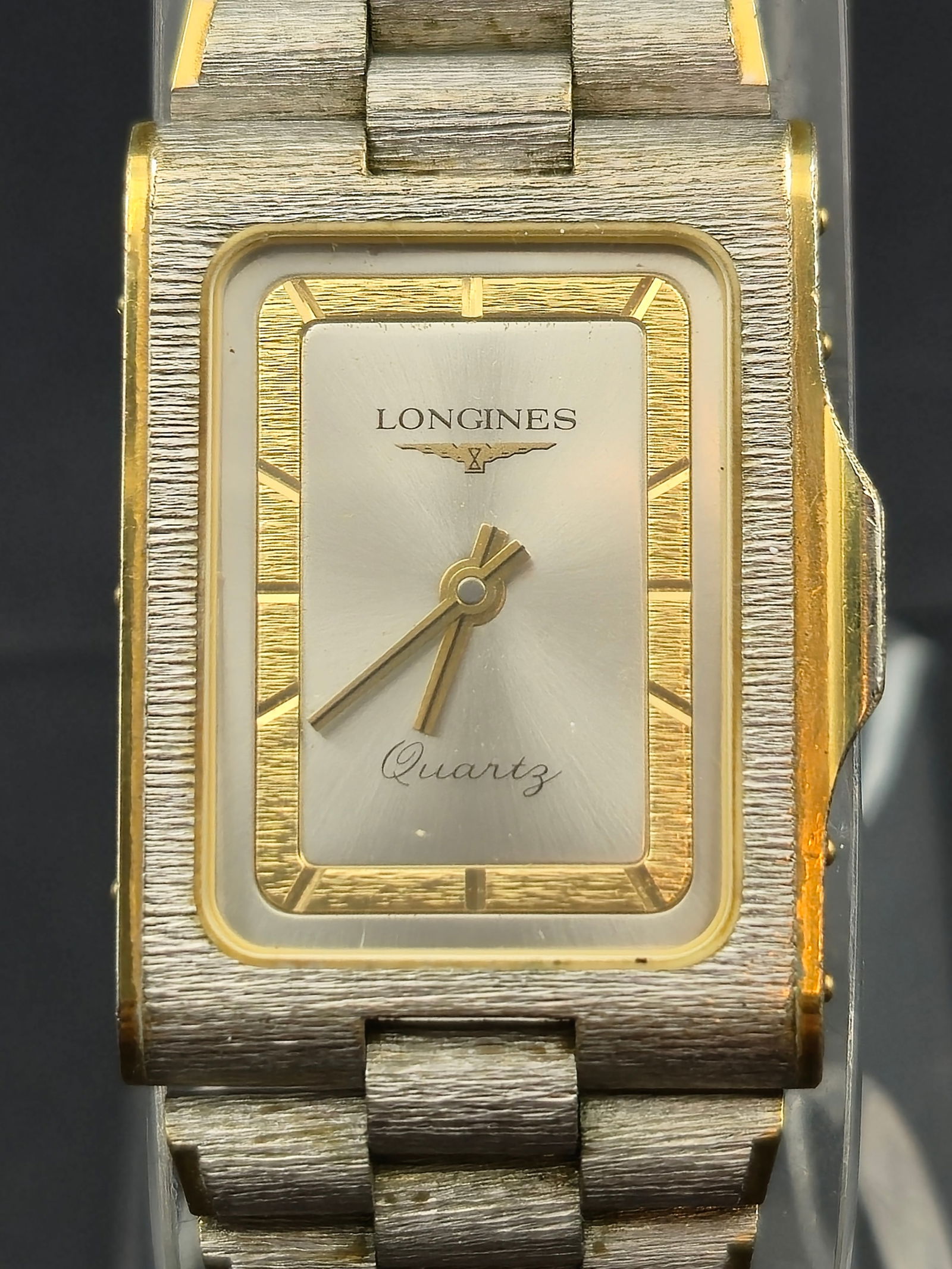 1970s Longines Tank Quartz Ref. MZ5705 28mm Rectangular Two-Tone Men’s Watch, 7J Swiss, Running: Vintage 1970s Longines “Tank Quartz” men’s wristwatch, reference MZ5705-0978. Rectangular case measuring approximately 28mm, stainless steel back marked “Stainless Steel Back, Base Metal B
