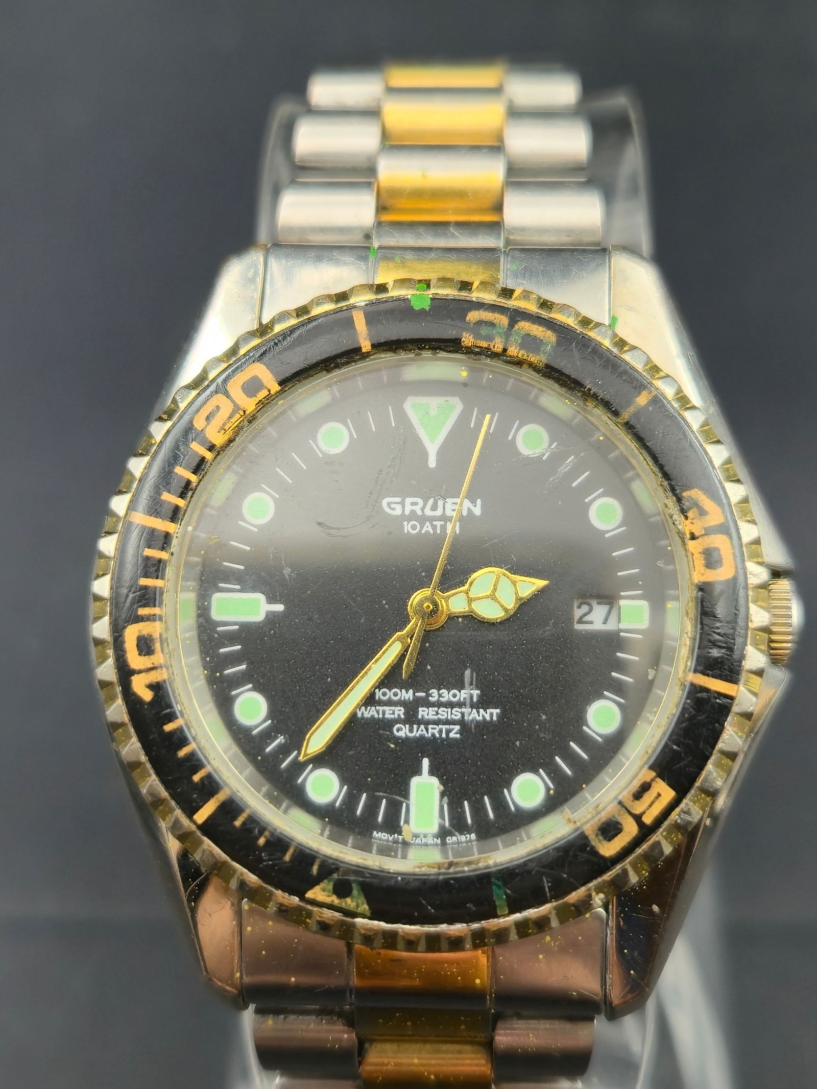 Gruen 305-PC32A Diver Quartz Watch 100M 38mm Two-Tone Stainless Steel: Vintage Gruen diver-style quartz wristwatch, reference 305-PC32A. Features a 38mm stainless steel case with black rotating bezel and two-tone stainless bracelet. Black dial with luminous indices, date