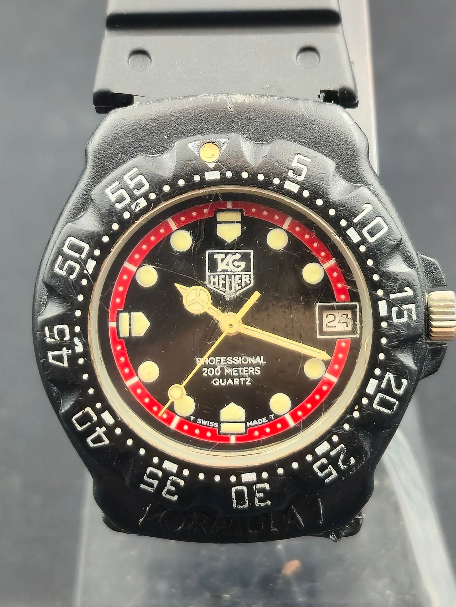 1980s TAG Heuer Formula 1 Ref. 383.513 Quartz Diver 200M 35mm Red/Black: Vintage 1980s TAG Heuer Formula 1 professional diver wristwatch, reference 383.513. Features a 35mm stainless steel and composite case with unidirectional bezel, black dial with red outer ring, lumino