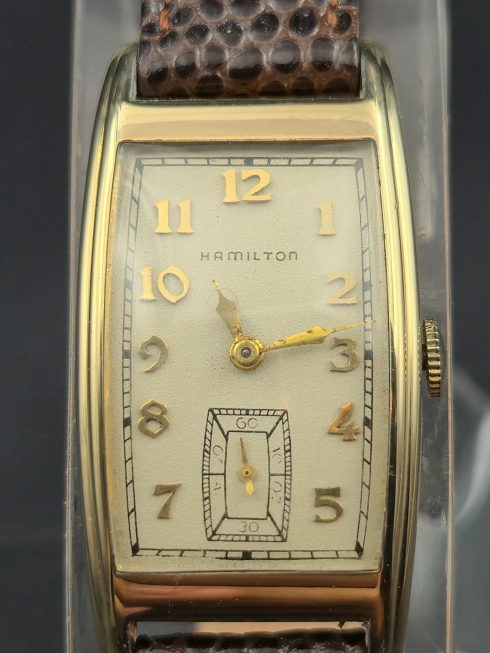 1940s Hamilton Brock “Tonneau Case” 10K Gold-Filled 24mm Men’s Dress Wristwatch 980 17J: Vintage 1940s Hamilton “Brock,” commonly nicknamed the “Tonneau Case” for its gently curved rectangular barrel design. The 10K gold-filled Wadsworth case measures 24mm across and featu