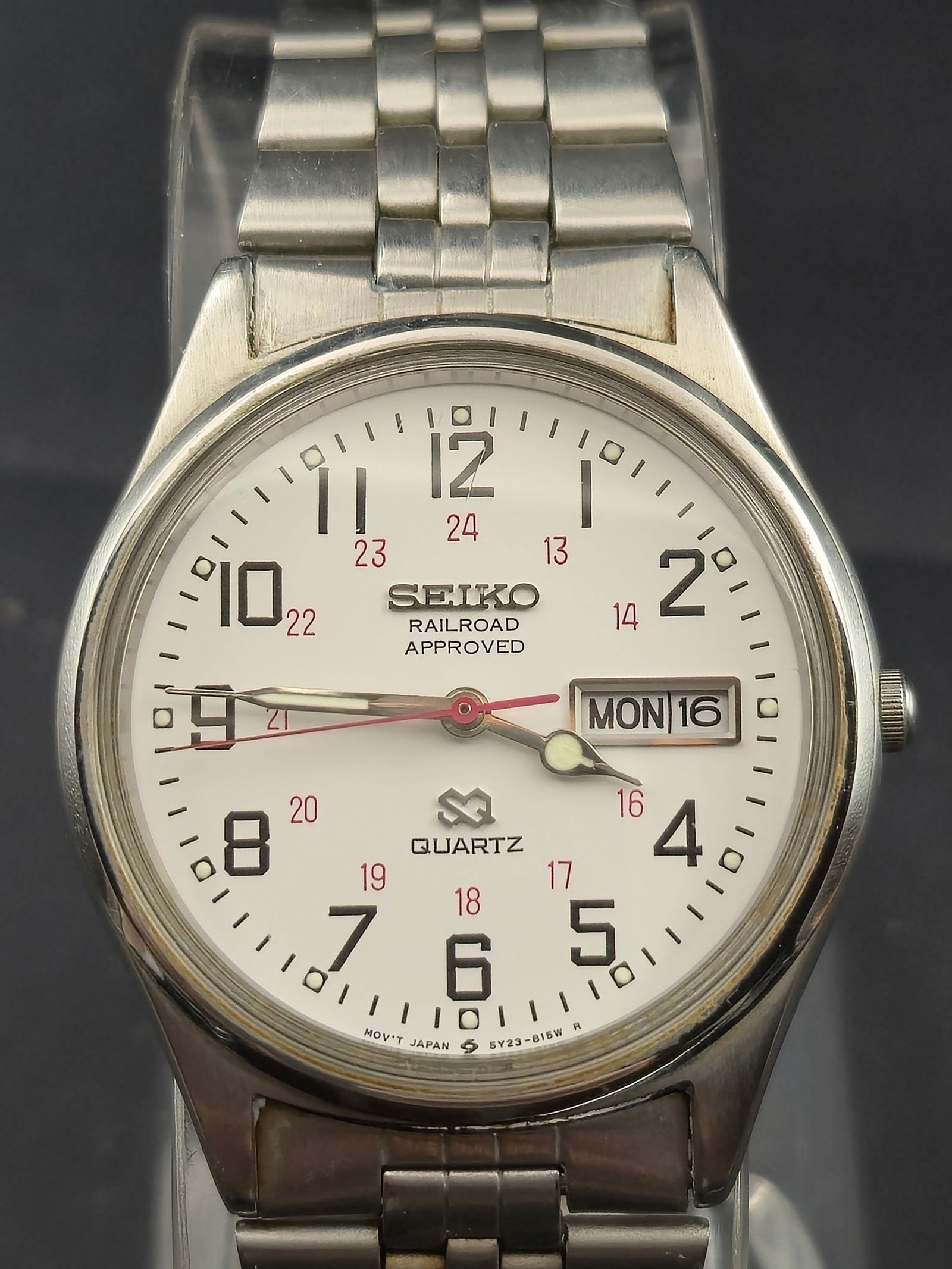 Seiko Railroad Approved Quartz 38mm Stainless Steel Watch Ref. 5Y23-8049, Day-Date, Running: Offered is a Seiko Railroad Approved quartz wristwatch, reference 5Y23-8049, housed in a stainless steel case measuring 38mm in diameter. The white dial features bold black Arabic numerals with inner