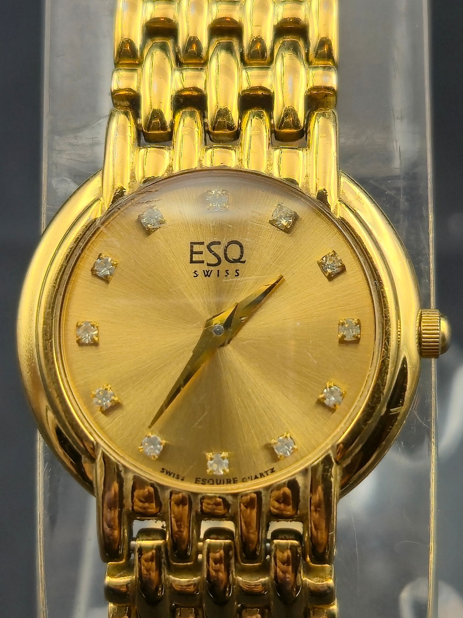 ESQ Swiss 24mm Gold-Tone Quartz Watch with Diamond Markers Running: Elegant ESQ (Esquire) Swiss quartz wristwatch with gold-tone case and integrated bracelet. Case measures 24.6mm (excluding crown). Gold-tone dial signed “ESQ Swiss” with twelve diamond-accent