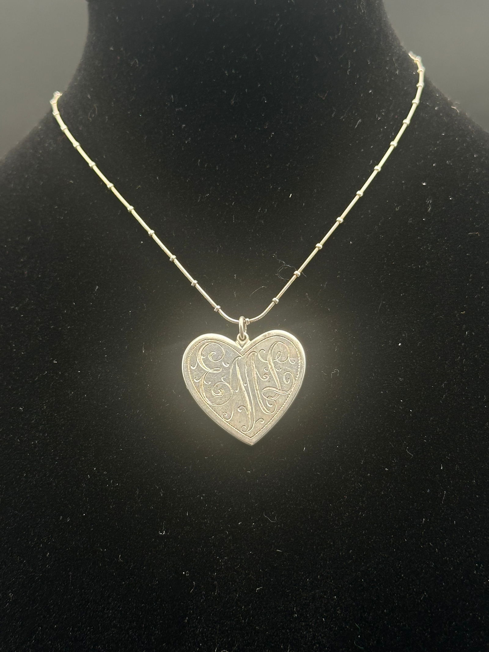 Vintage Sterling Silver Heart Pendant Necklace with Engraving, 18.4g: A vintage sterling silver necklace featuring a heart-shaped pendant engraved with a decorative monogram “M” on the front. The reverse is inscribed with the heartfelt message “All my Love, Ra