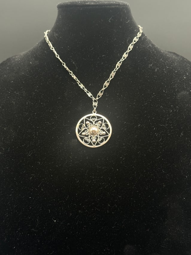 Vintage Sterling Silver Filigree Medallion Pendant Necklace: Delicate vintage sterling silver necklace featuring an ornate circular filigree medallion with intricate scrollwork and bead accents. The finely crafted chain showcases matching filigree links, adding