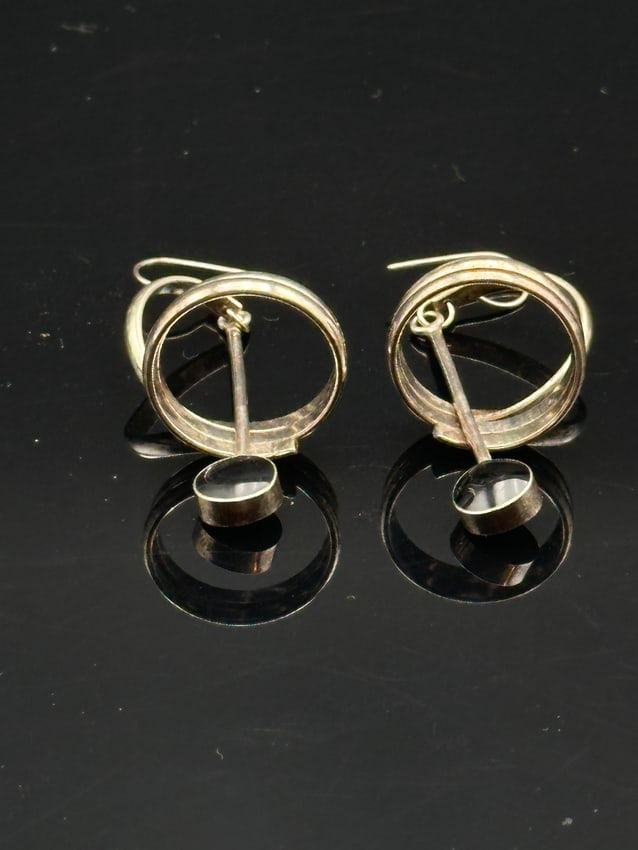 Vintage Modernist Sterling Silver & Abalone Dangle Earings: Elegant vintage modernist earrings crafted from sterling silver, featuring bold triple-hoop circles with suspended abalone shell accents. The natural abalone displays iridescent green and blue tones,