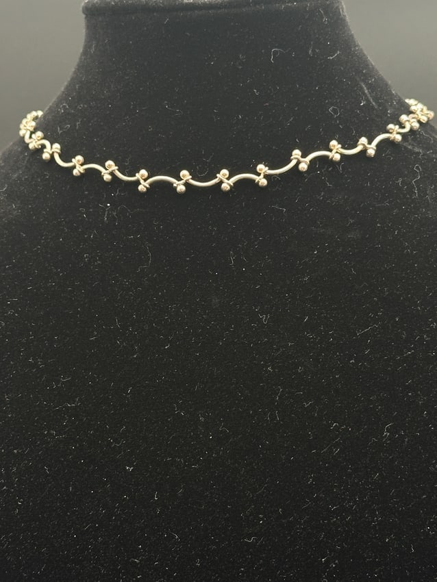 Vintage Sterling Silver Ball & Curve Link Choker Necklace: Elegant vintage choker necklace crafted from sterling silver, featuring a unique curved link design accented with polished silver ball details. Lightweight yet bold, this timeless piece sits beautiful