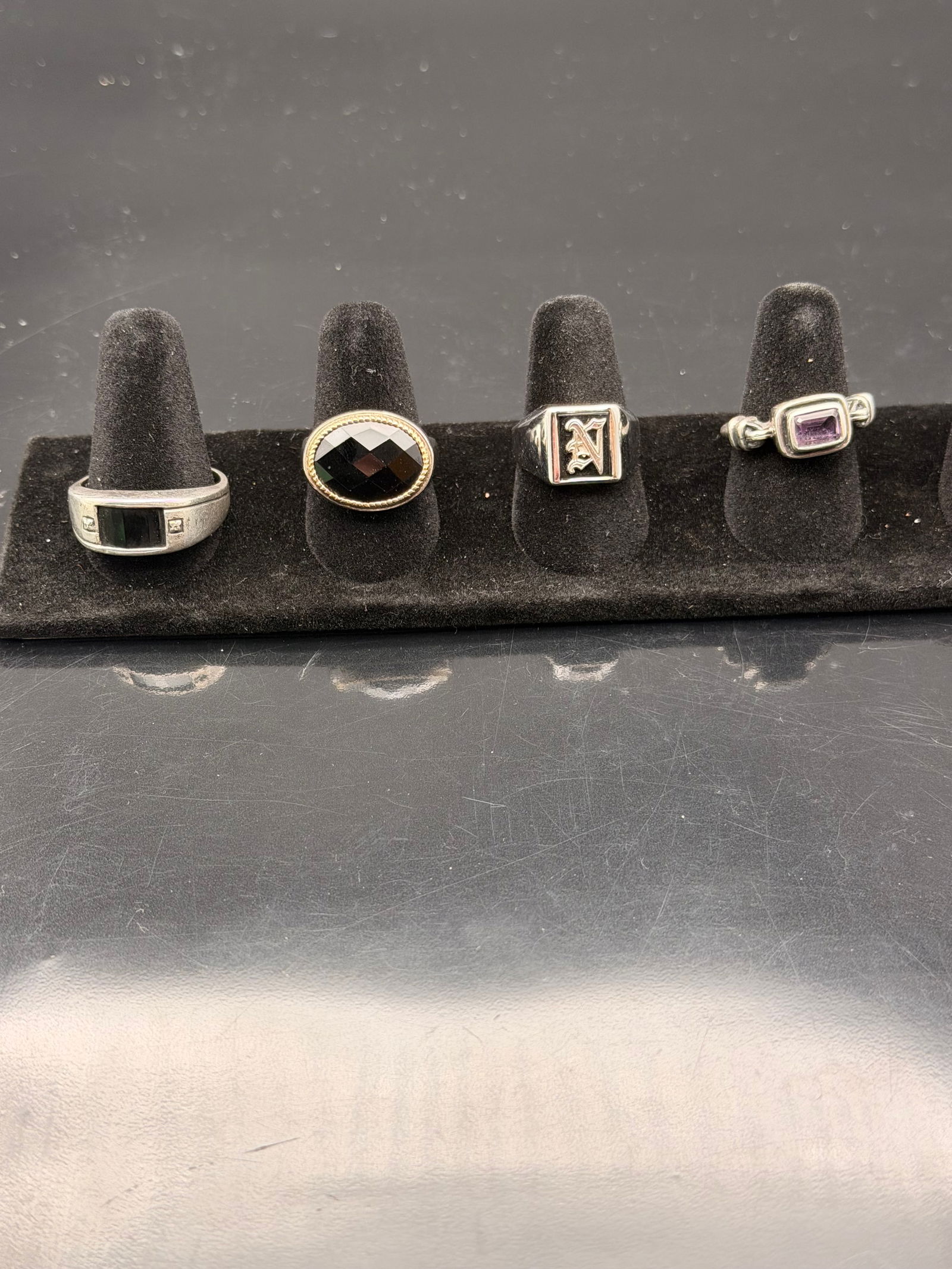 Lot of 4 Vintage Men’s Rings – Sterling & Mixed Metal – Onyx, Amethyst, Monogram “A”: Lot of four vintage men’s rings featuring various designs and materials. Includes sterling silver and mixed metal bands with faceted onyx, amethyst-colored, and engraved letter “A” detail. S