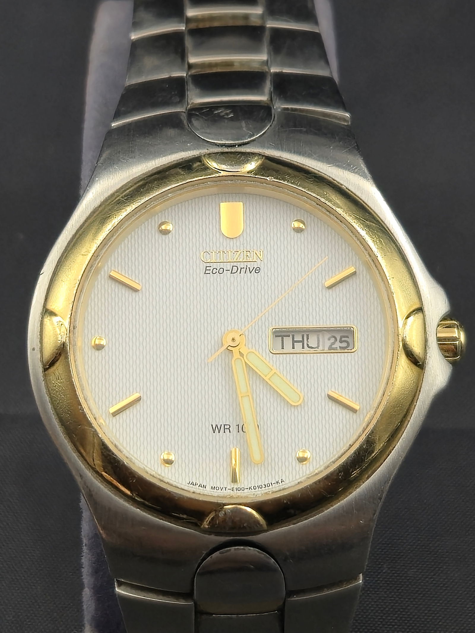 Citizen Eco-Drive Men’s Watch E101-K17543 38mm Two-Tone Stainless Day-Date Runs: A classic Citizen Eco-Drive men’s wristwatch, model E101-K17543, powered by solar technology with no need for battery replacement. Features a 38mm stainless steel case with gold-tone bezel, textured