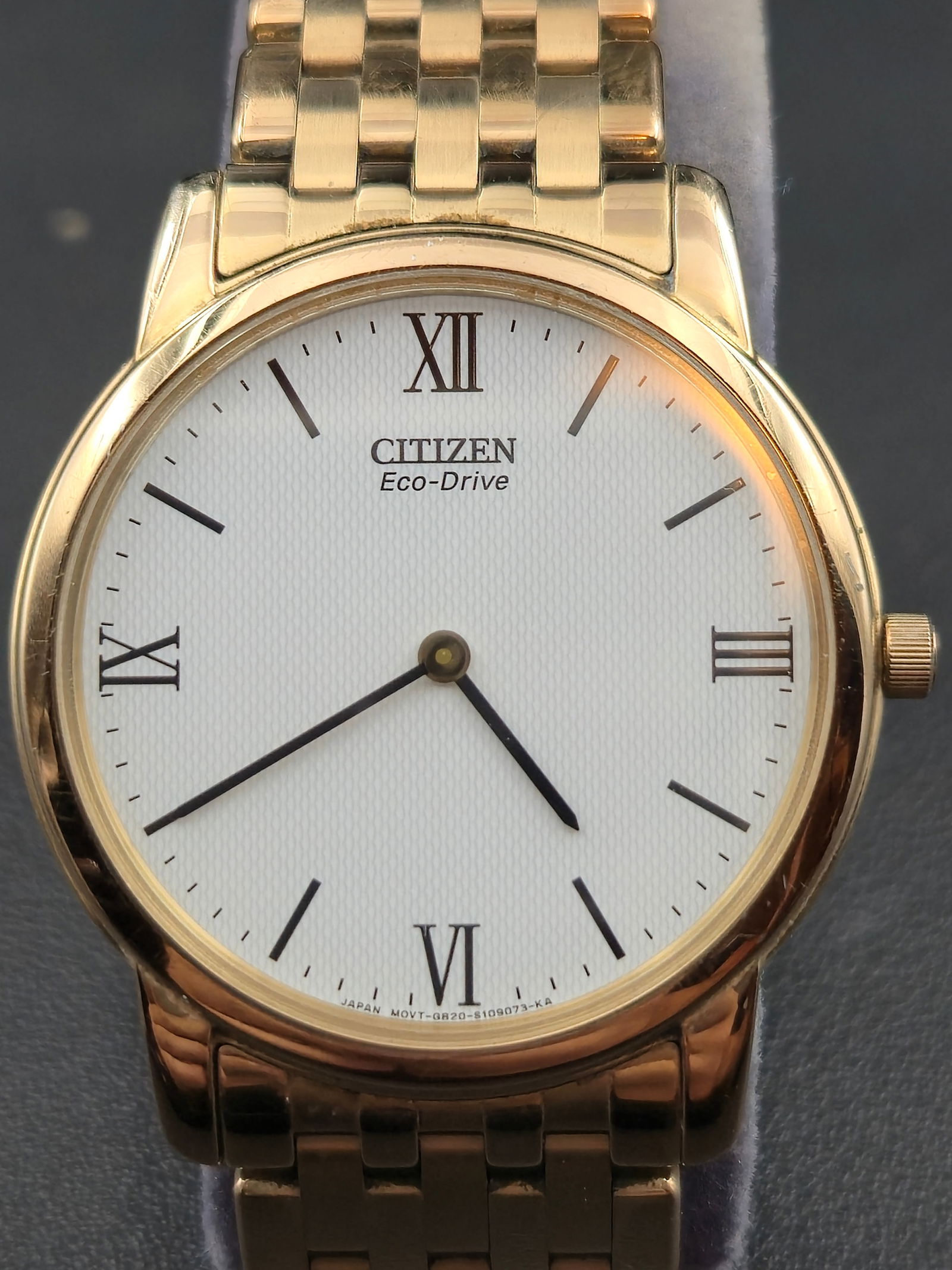 Citizen Eco-Drive Stiletto 36mm Ultra-Thin Gold-Tone Watch w/ Roman Dial, Running: Citizen Eco-Drive Stiletto men’s wristwatch, a slimline dress model with ultra-thin case design and solar-powered movement. Features a 36mm gold-tone case with sapphire crystal, white textured dial,