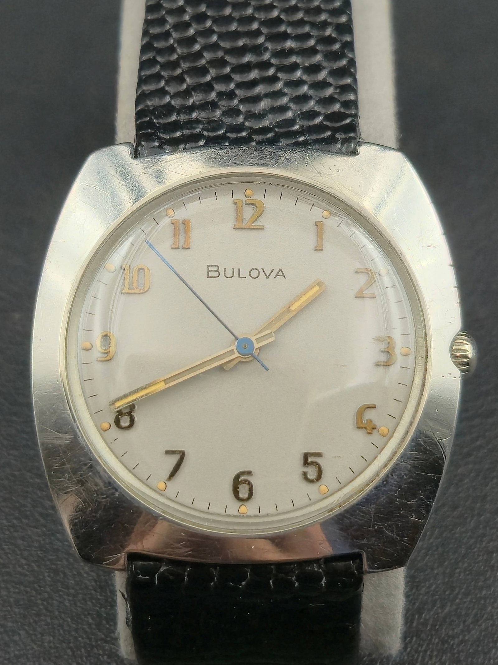 1972 Bulova 11ANC Swiss Manual Wind 17J 32.8mm Vintage Wristwatch (Running): Vintage 1972 Bulova manual-wind wristwatch featuring a Swiss-made 17-jewel Caliber 11ANC movement housed in a stainless-steel case. The silver dial displays gold-tone Arabic numerals with matching han