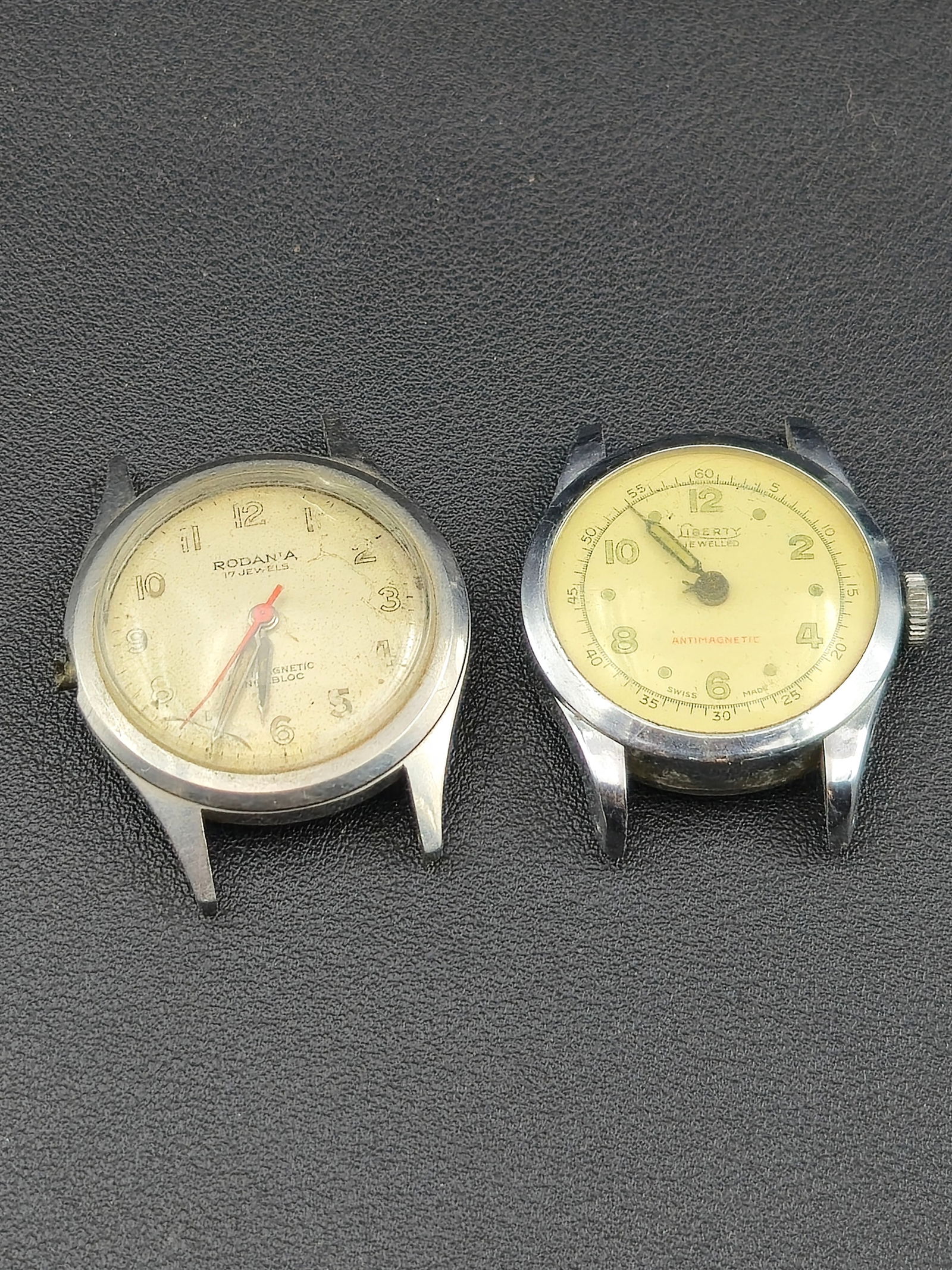 1940s–50s Rodania & Liberty “Swiss Field Watch Pair” Manual Wind: Lot of two vintage Swiss-made wristwatches in classic postwar field-watch style, both untested.The first is a Rodania 17-jewel Incabloc manual-wind watch with luminous Arabic numerals, red sweep secon