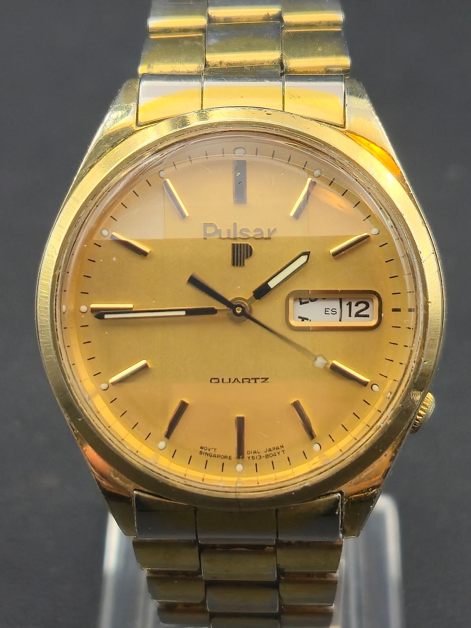 1980s Pulsar Y513-8039A5 Gold-Tone Quartz 36mm “Faceted Crystal” Wristwatch – Running: vintage 1980s Pulsar Y513-8039A5 quartz wristwatch featuring a striking faceted mineral crystal and elegant gold-tone dial with day-date display. The case measures 36mm, fitted to an integrated gold-t