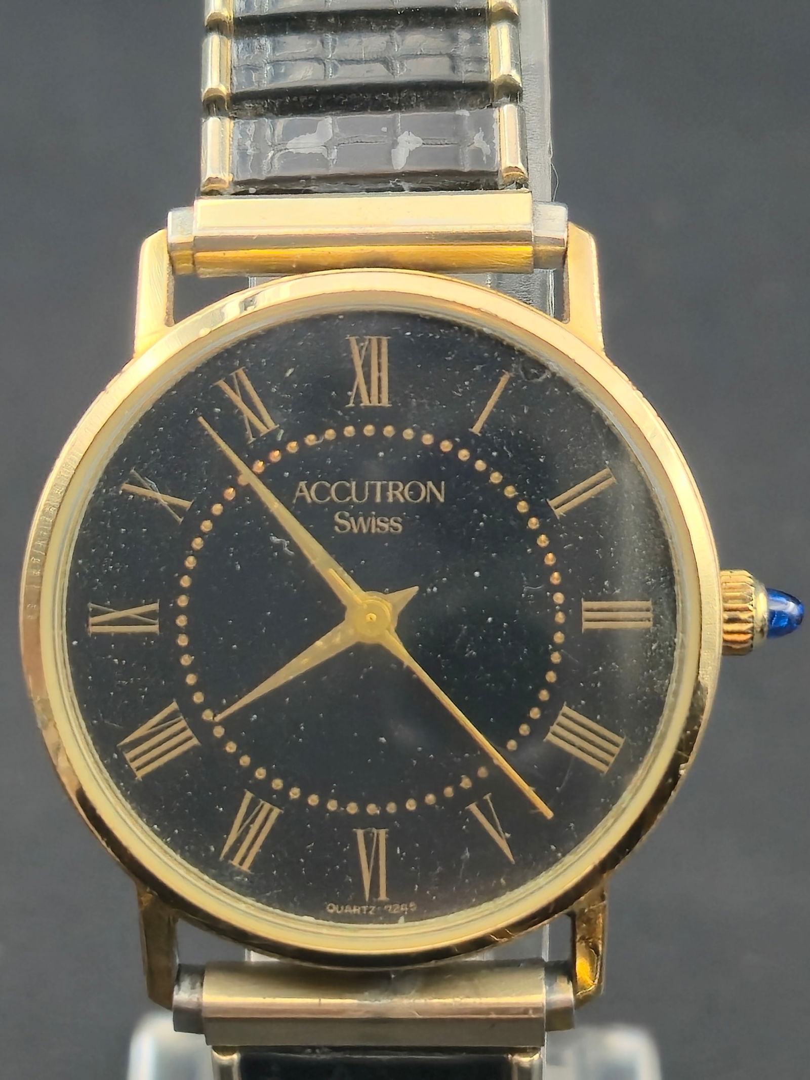 1980s Bulova Accutron Swiss Quartz 4J Dress Watch C8485 Black Roman Dial 31.9mm – Running: Elegant 1980s Bulova Accutron Swiss Quartz men’s wristwatch, model C8485, powered by a Bulova 4-jewel Swiss quartz movement. The watch features a classic black dial with gold Roman numerals and matc