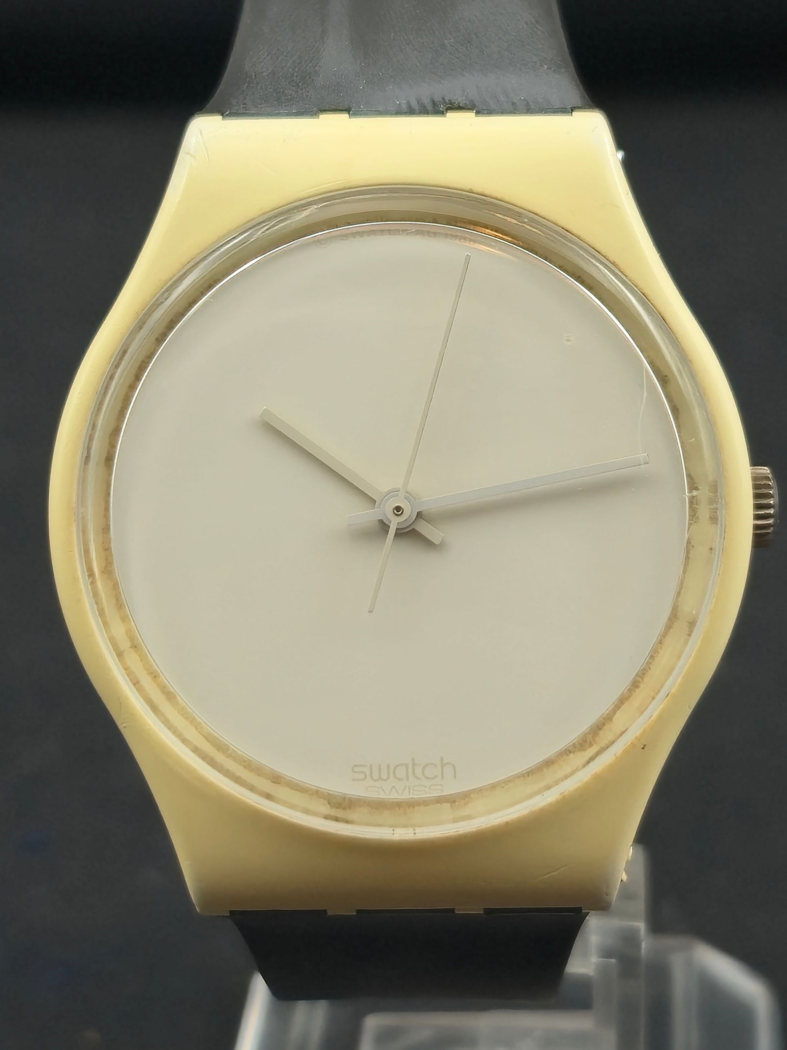 1985 Swatch “White Out” GW107 Quartz 33.6mm Swiss Made with Original Case: Minimalist early-production Swatch “White Out” model (ref. GW107), circa 1985. Features a matte-white dial with matching hands, ivory plastic case, and black perforated rubber strap. Includes