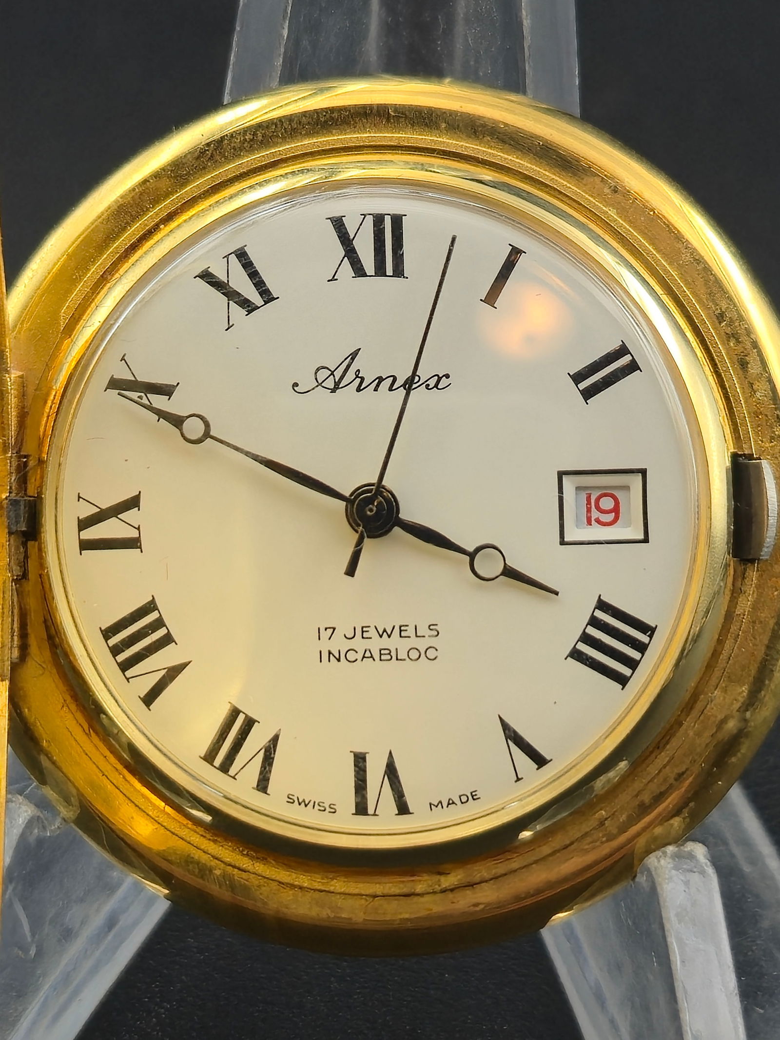 1970s Arnex Swiss 17J Incabloc Pocket Watch – Gold-Tone Textured Case – Date Window – Running: Vintage Arnex Industries Corp. Swiss-made mechanical pocket watch, circa 1970s, powered by a 17-jewel Incabloc movement marked Arnex – Swiss – 17 Jewels – Unadjusted. The movement features jewel