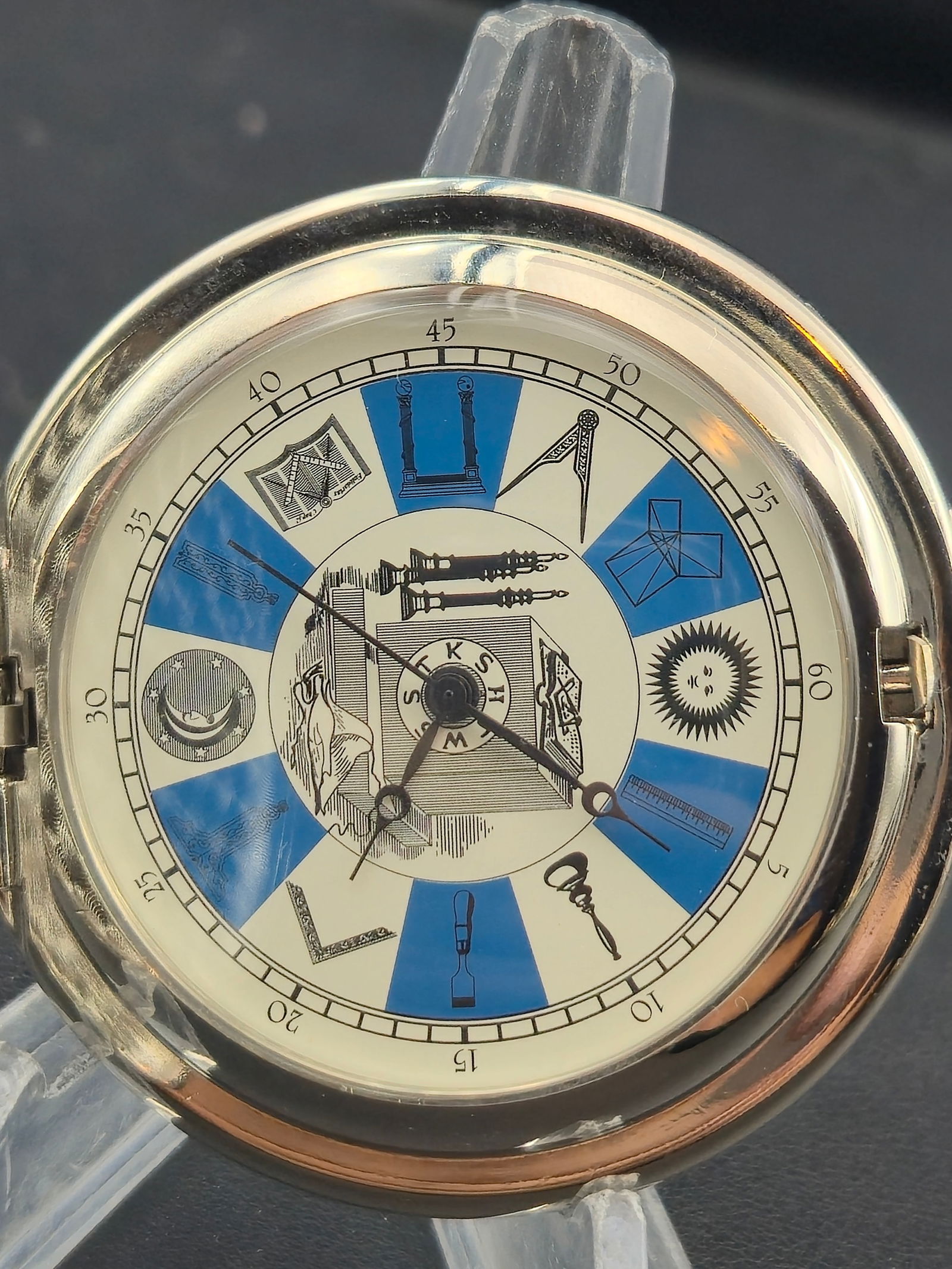 Masonic Symbol Quartz Pocket Watch Silver & Gold Tone (55mm, New Battery, Runs): Striking modern quartz pocket watch featuring detailed Masonic symbolism throughout. The silver-tone case is accented with a raised gold Square and Compasses “G” emblem on the cover and sunbur