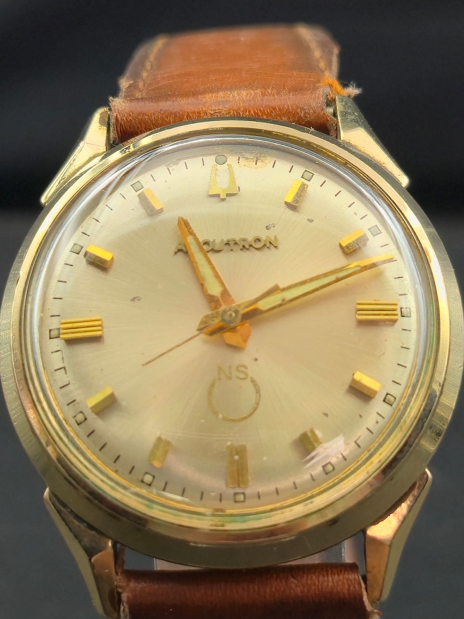 Bulova Accutron 214 “NS” Northern States Power Co. Presentation Watch (1967, 34mm): Vintage Bulova Accutron presentation wristwatch featuring the U.S.-made Caliber 214 tuning-fork movement. The gold sunburst dial bears the “NS” logo of Northern States Power Co., given to empl
