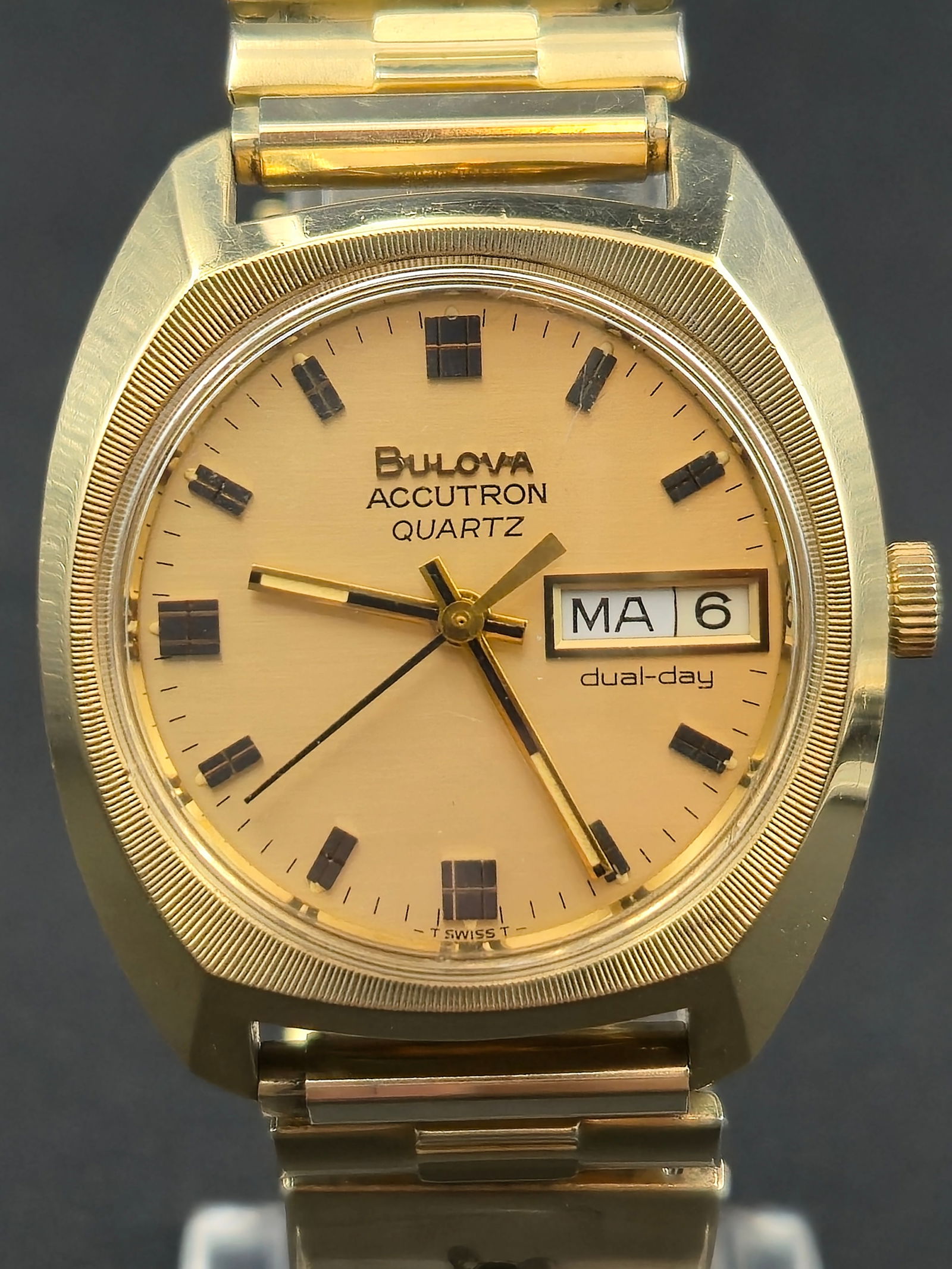 Bulova Accutron Quartz Dual-Day Gold-Tone Wristwatch (1978, 34mm, Running): Vintage Bulova Accutron Quartz Dual-Day wristwatch, Swiss-made and powered by Bulova’s early quartz movement. Features a brushed champagne dial with applied black and gold hour markers, day-date win