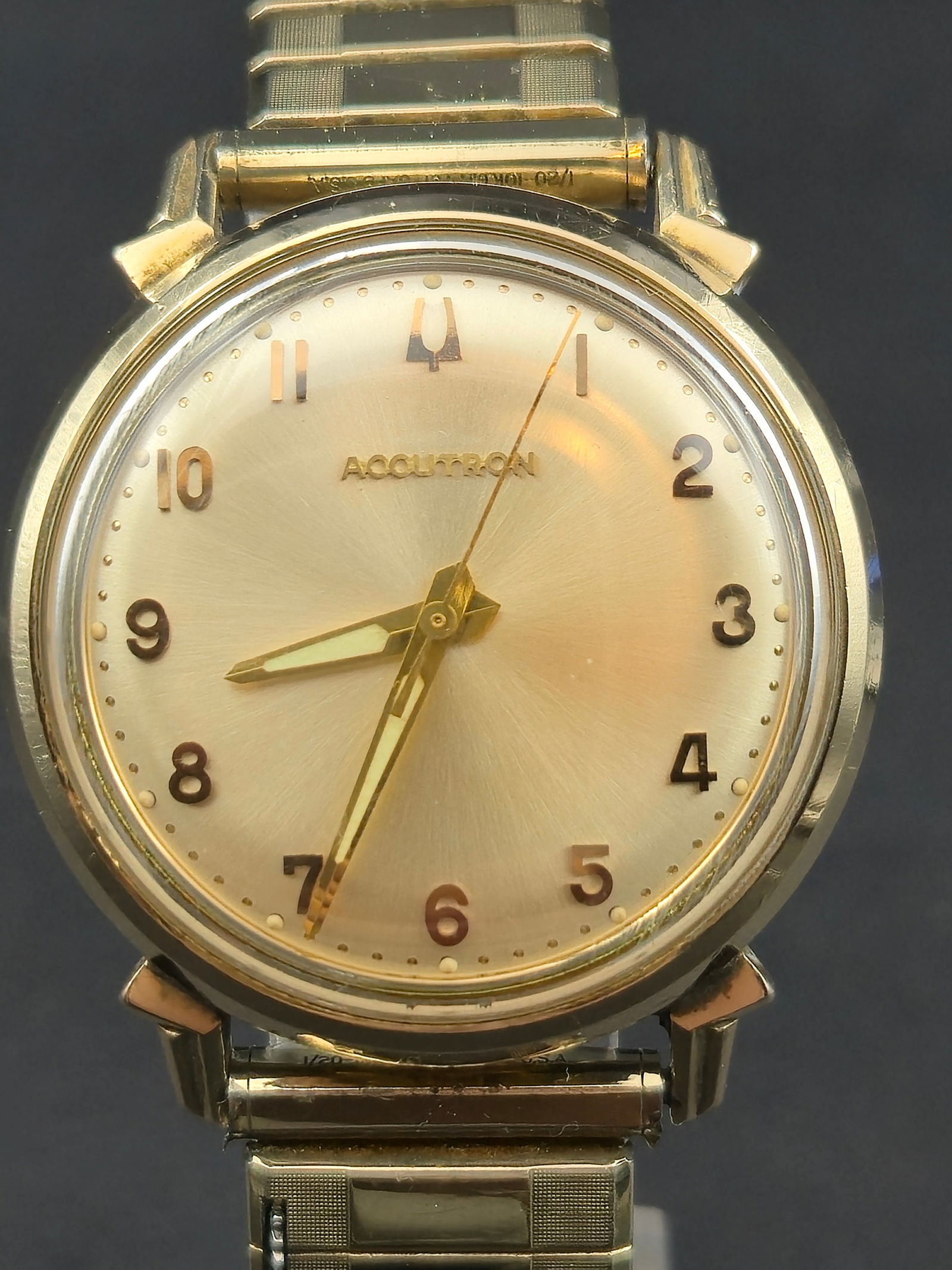 Bulova Accutron 214HN 10K Gold-Filled Bezel Wristwatch (1968, 34.8mm, Running): Vintage Bulova Accutron wristwatch featuring the rare Caliber 214HN tuning-fork movement, made in the U.S.A. The elegant champagne sunburst dial displays gold Arabic numerals and the applied Accutron