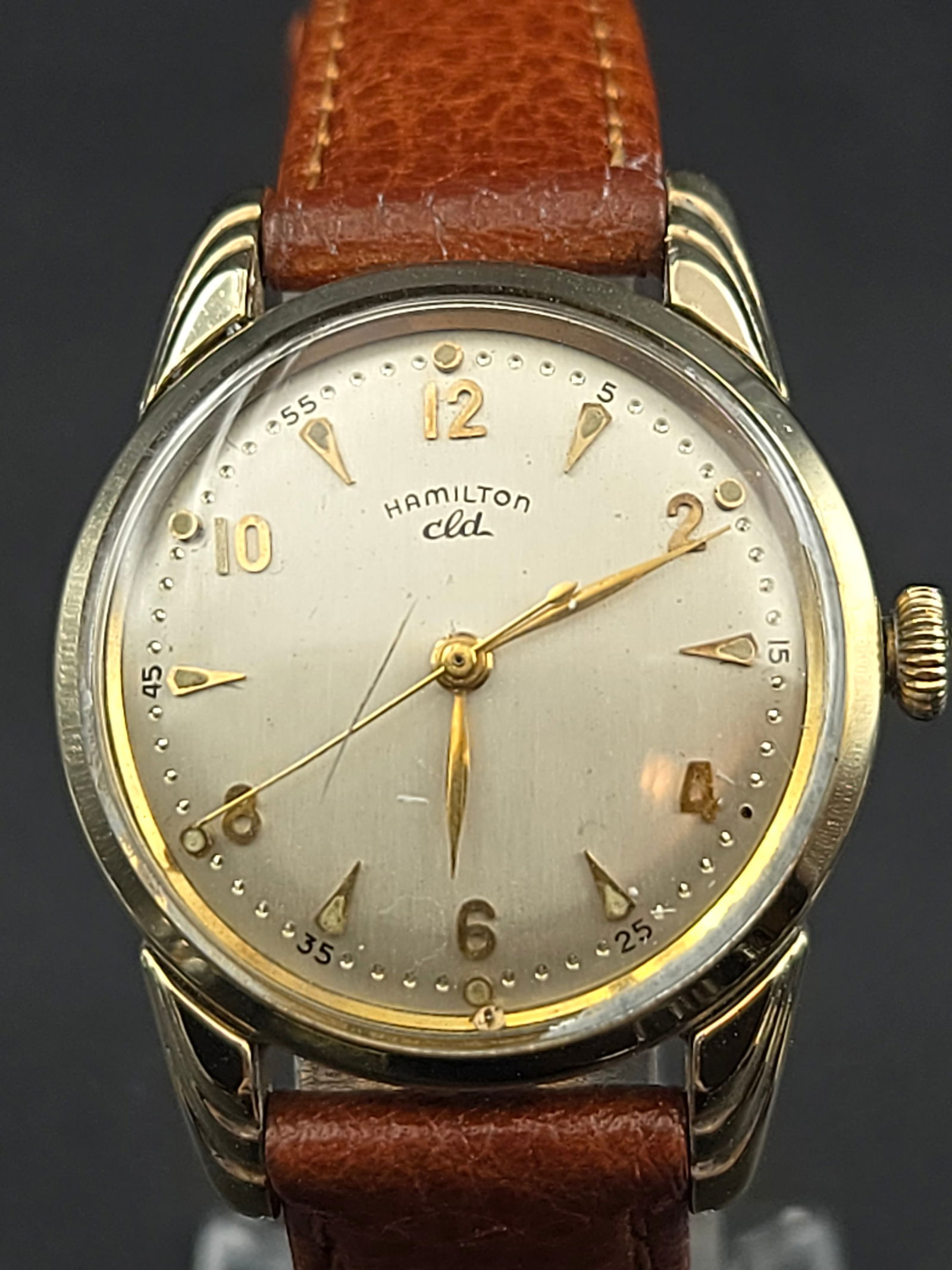 Hamilton CLD “Alden” 10K Gold-Filled 31 mm Manual 18J Wristwatch (1953): vintage Hamilton “Alden” CLD wristwatch, circa 1953, featuring a 10K gold-filled case with distinctive flared lugs and original signed Hamilton crown. The silver dial has applied gold Arabic n