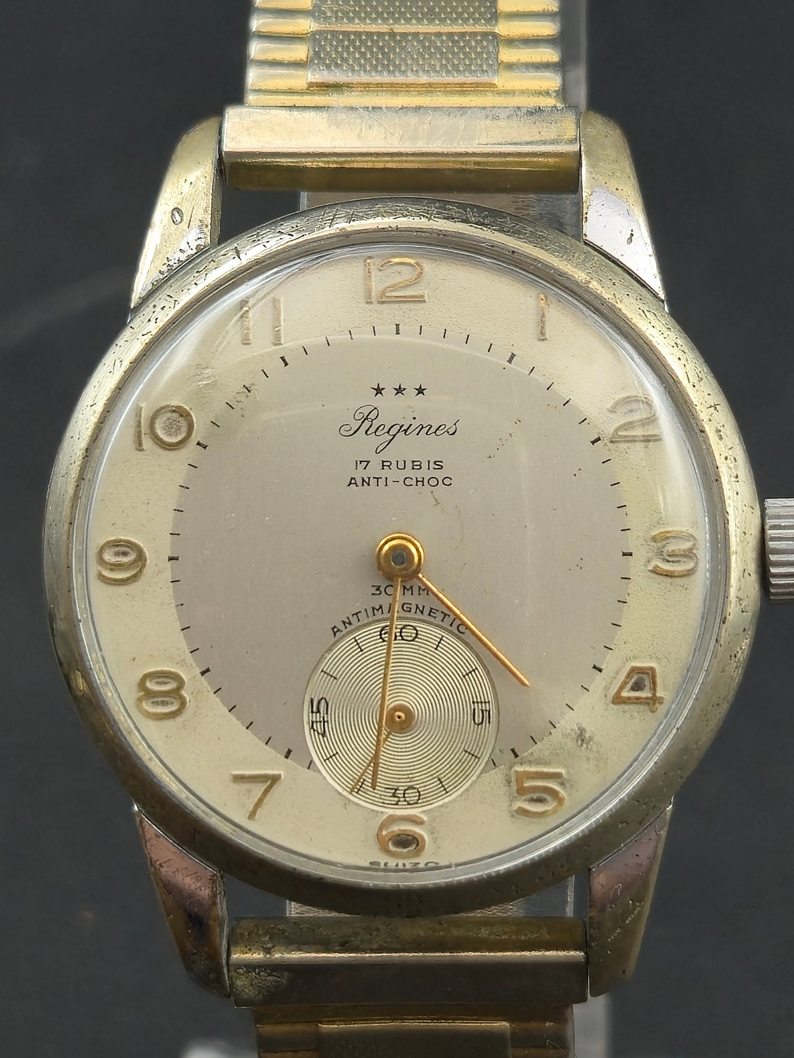 1950s Regines 17 Jewel Swiss Manual Wind 34 mm Wristwatch: Vintage Regines wristwatch made in Switzerland during the 1950s, powered by a 17 jewel Swiss manual wind movement marked Regines Anti Choc Swiss Made Caliber 1350. The movement features fine finishing