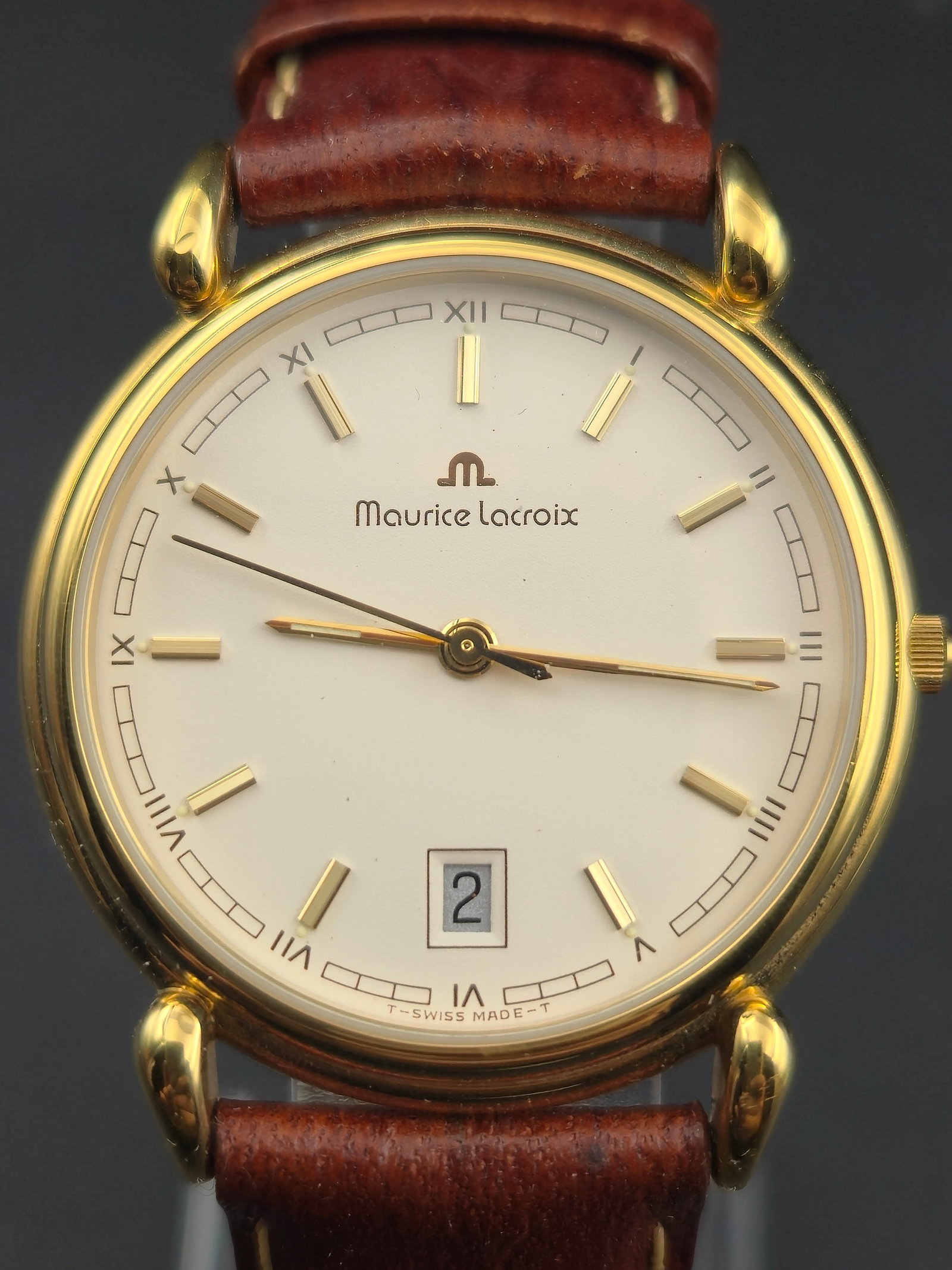 Maurice Lacroix Swiss Quartz Gold-Plated Dress Watch 33mm w/ Box – NOS: Elegant Maurice Lacroix Swiss-made quartz wristwatch in new old stock condition, presented in its original blue Maurice Lacroix box. The watch features a gold-plated 10m case with polished round bezel