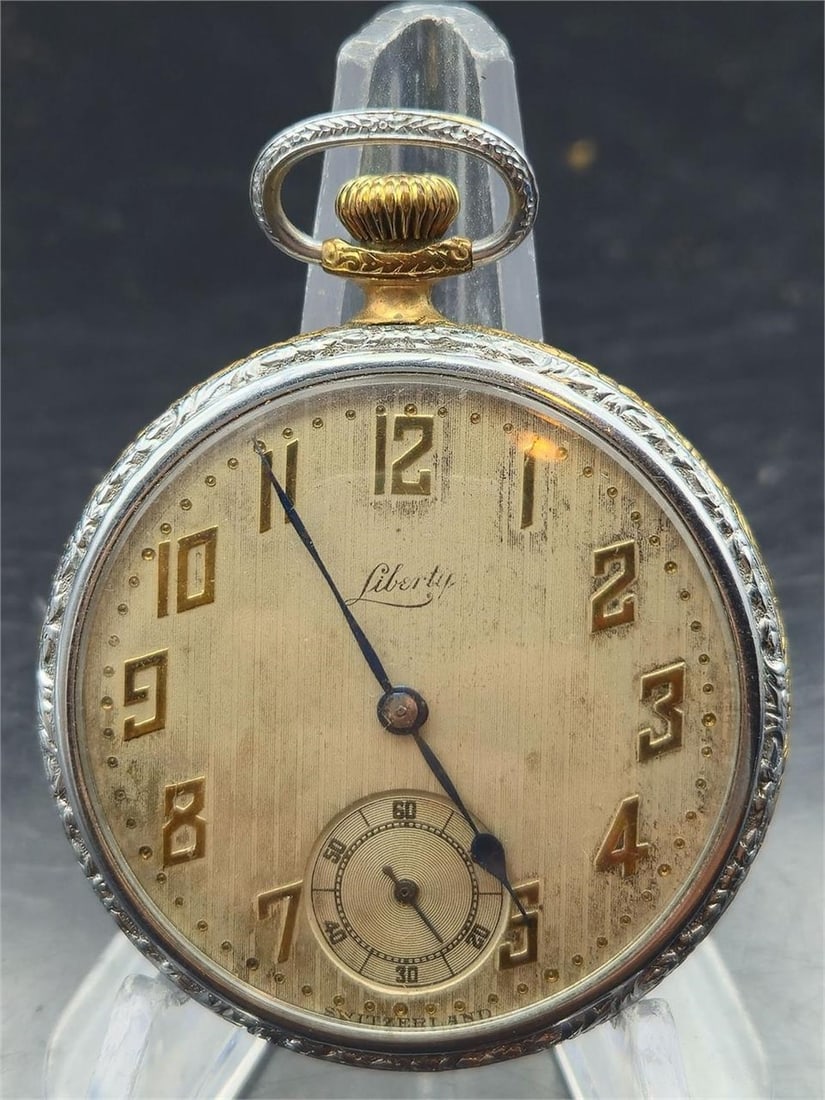 Liberty Swiss 7J Pocket Watch Two-Tone Case: Vintage Liberty Swiss pocket watch featuring a gold-tone dial with raised gold Art Deco numerals, a recessed seconds subdial at 6, and elegant blued steel hands. The movement is marked “Liberty&rdqu