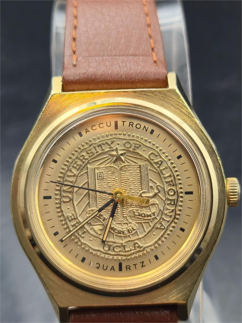 1978 Bulova Accutron UCLA Quartz Watch 35mm: Vintage Bulova Accutron quartz wristwatch, commemorating the University of California, Los Angeles (UCLA), dated to 1978 (case marked “N8”). Features a gold-tone case measuring approximately 3