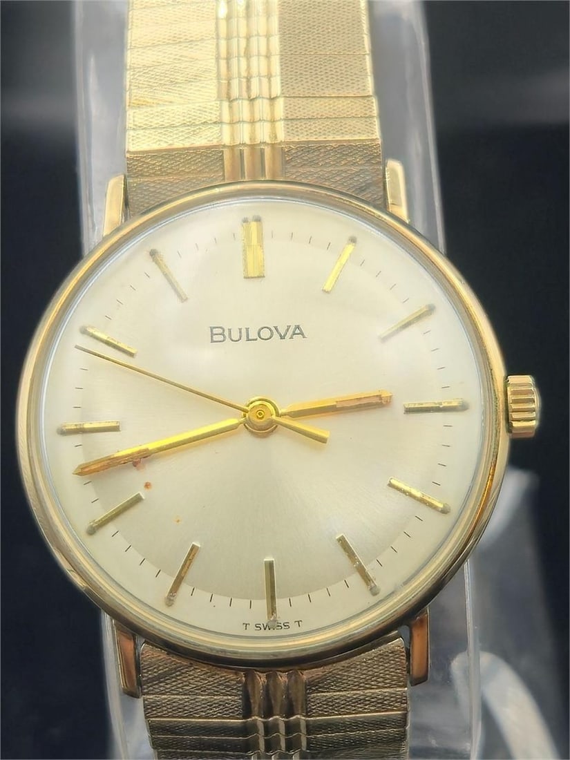 1959 Bulova 10K RGP Dress Watch with Box: This elegant vintage Bulova wristwatch from 1959 features a 10K rolled gold plate (R.G.P.) case with a curved rectangular design, silver-tone dial, and classic numeral/marker layout. Powered by a Bulo