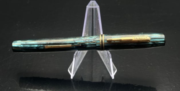 Vintage Trupoint Blue Pearl Celluloid Fountain Pen – Gold-Plated Trim & Nib – 1930s/40s: A vintage Trupoint fountain pen, produced in the 1930s–1940s, featuring a beautiful blue pearl striated celluloid body and cap with gold-plated trim. The pen has a classic Art Deco styling with a st