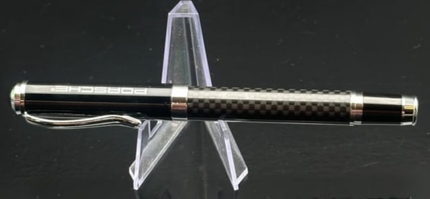 Porsche Design P’3110 TecFlex Black Rollerball Pen: A luxury Porsche Design P’3110 TecFlex rollerball pen, crafted in stainless steel with black braided TecFlex weave, accented by polished chrome fittings. The pen reflects Porsche’s engineering pre